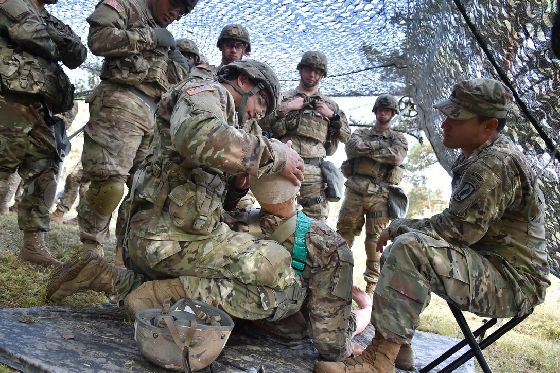 Soldiers train to apply first aid for an open head wound during the Expert Infantryman Badge training at the 7th Army Training Command’s Grafenwoehr Training Area, Germany, Oct. 17, 2016. The purpose of the Expert Infantryman Badge is to recognize Infantrymen who have demonstrated a mastery of critical tasks that build the core foundation of individual proficiency that enables them to locate, close with, and destroy the enemy through fire and maneuver and repel an enemy assault in close combat. Army photo by Gertrud Zach