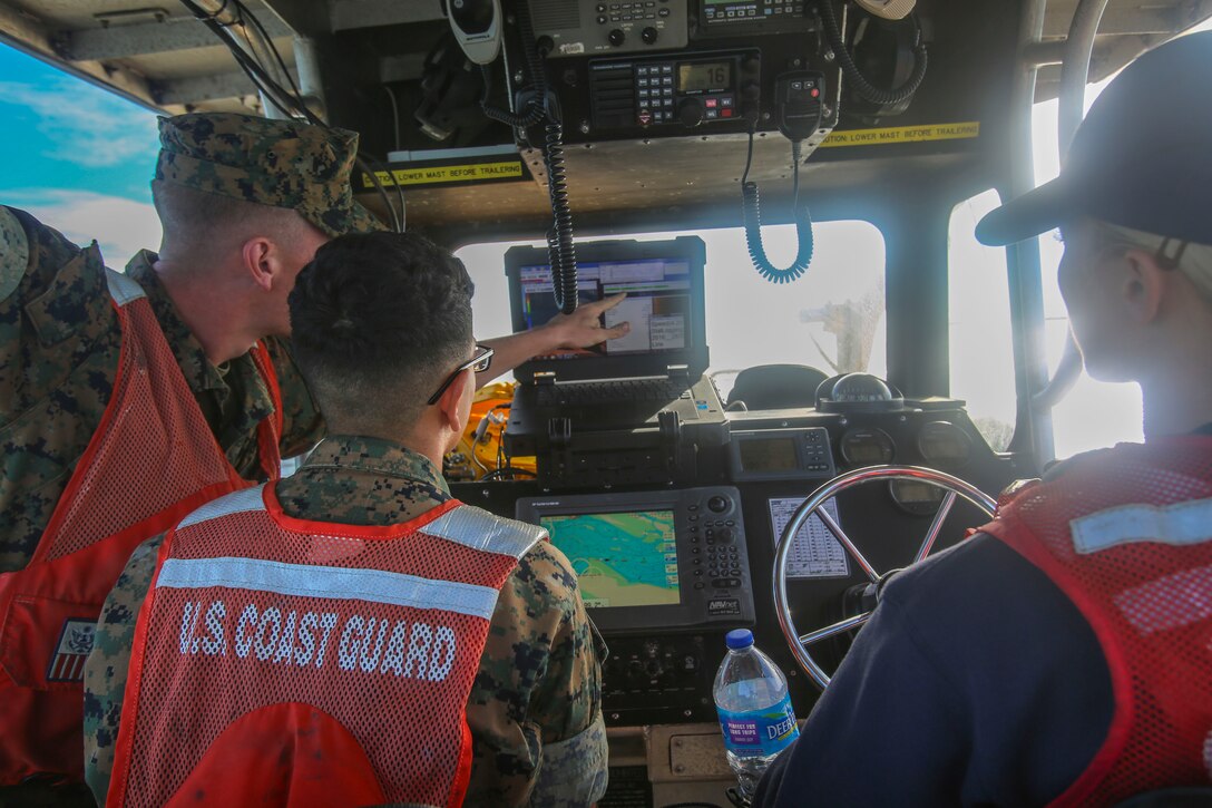 Lance Cpl. Aidan Pedersen analyzes maps with Lance Cpl. Rigo Estrada during a joint training exercise near U.S. Coast Guard Station Fort Macon, N.C., Oct. 13, 2016. The Marines worked alongside Coast Guardsmen to map out the sea floor and update maps. Pedersen and Estrada are both geographic intelligence analysts with 2nd Intelligence Battalion. (U.S. Marine Corps photo by Lance Cpl. Jon Sosner)