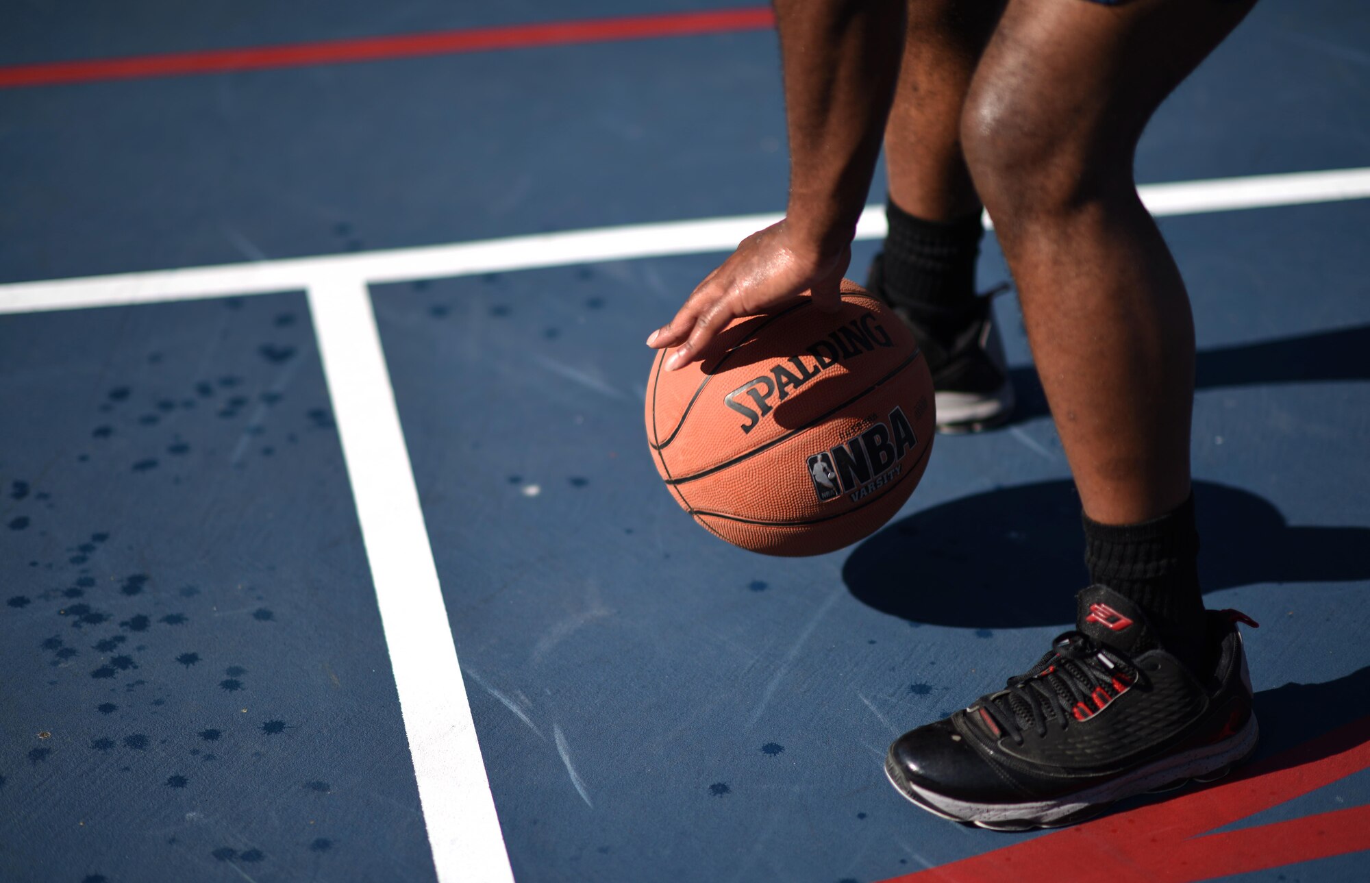 Airman 1st Class Daryl Parker, 608th Air Operations Center offensive duty technician, dribbles a basketball as part of his warm-up drills at Barksdale Air Force Base, La., Oct. 12, 2016. Parker started playing basketball at a young age and continues to maintain his physical fitness on the court. (U.S. Air Force photo/Senior Airman Damon Kasberg)