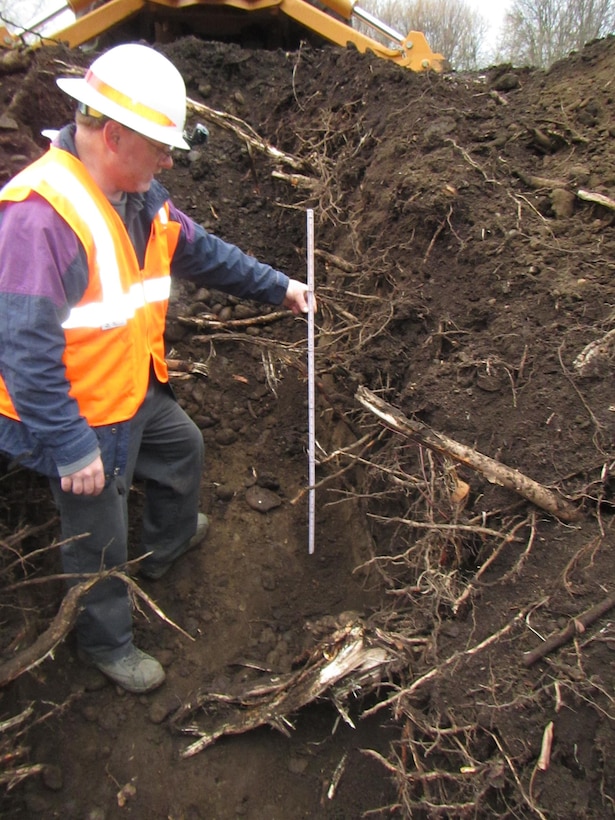 Michael Shaffer, a civil engineer from the U.S. Army Corps of Engineers’ Walla Walla District, measures the depth of root intrusion on the Mill Creek Levee Dec. 9, 2015, following Phase-1 maintenance removal of the land-side vegetation which jeopardized the structural integrity of the levee. District Geotechnical Section levee experts examined several test pits excavated at various points along the mile-long levee and determined removing problematic roots would require “grubbing” roughly two feet into the levee. In some locations, where tree roots have extended deeper into the levee structure, more extensive excavation and repairs may be required. Phase-2 repair work on the south levee from the division works beginning near the Mill Creek Office, progressing toward the Jones Ditch is slated to begin in early December 2016 and take approximately 3 months to complete. Additional Phase-2 repair work will occur as funding becomes available.