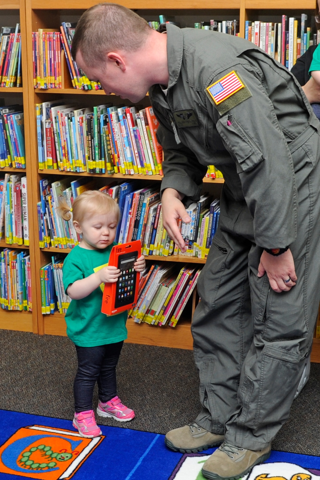 Cassidy Andersen, age two, looks at an electronic reader with her father, Senior Airman Glenn Andersen, a direct support operator with the 19th Special Operations Squadron, at Hurlburt Field, Fla., Oct. 17, 2016. Cassidy accumulated more than 1,100 minutes reading along with her parents as part of a two-month long summer reader program. (U.S. Air Force photo by Staff Sgt. Kentavist P. Brackin)
