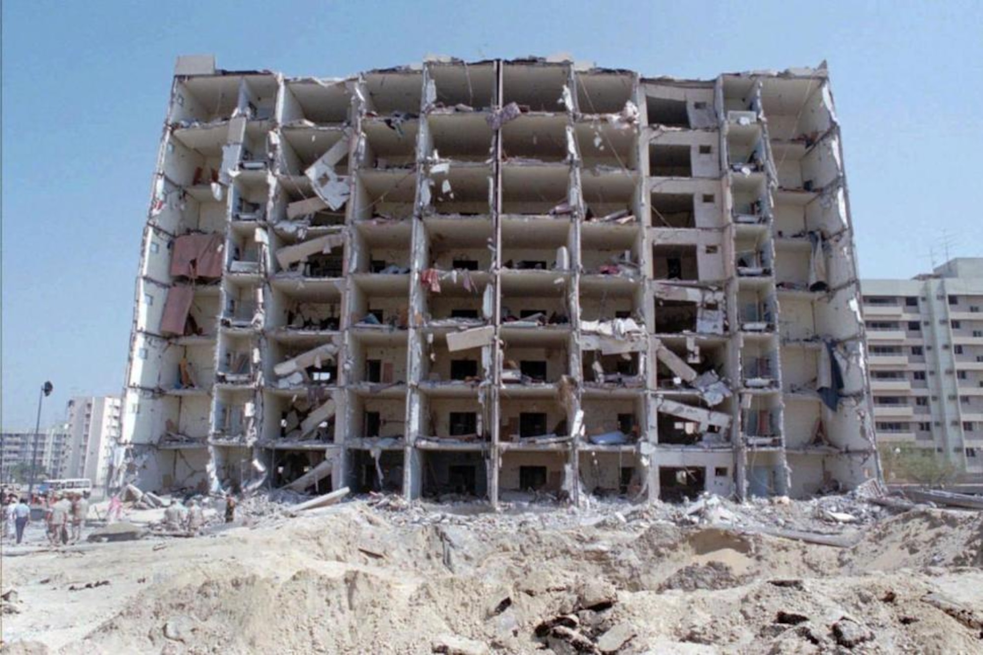 This June 30, 1996 file photo, shows a general view of the destroyed Khobar Towers and crater where a truck bomb exploded at a U.S military complex killing 19 Americans and injuring hundreds in Dhahran, Saudi Arabia. Ahmed al-Mughassil, suspected in the bombing has been captured, a U.S. official tells The Associated Press, Wednesday, Aug. 26, 2015. Al-Mughassil was described by the FBI in 2001 as the head of the military wing of Saudi Hezbollah. (AP Photo by Saleh Rifai, File)