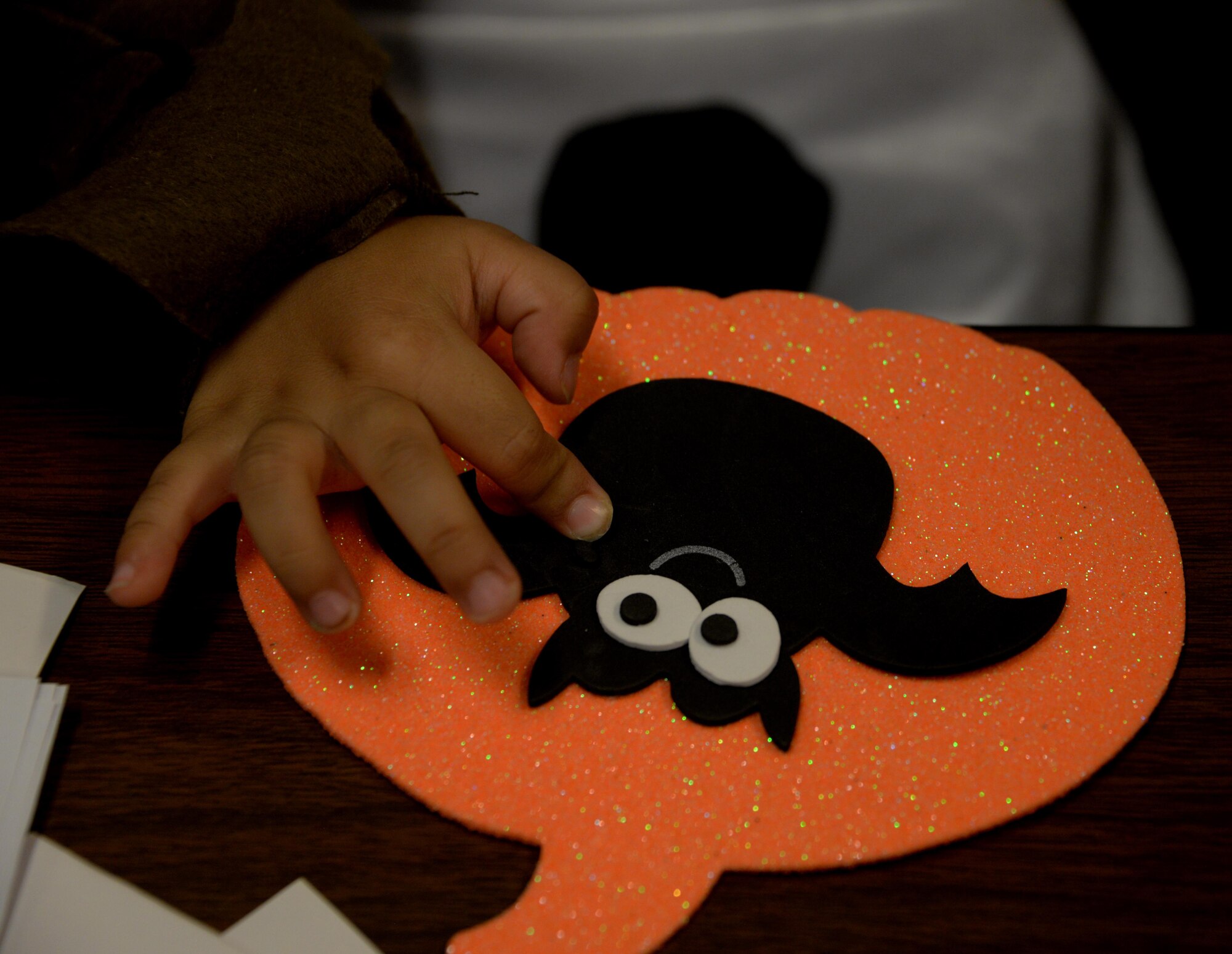 A Travis youth participates in arts and crafts during the Annual Exceptional Family Member Program Halloween Bash at Travis Air Force Base, Calif., Oct. 14, 2016. The event provided a safe atmosphere for special needs families to enjoy Halloween festivities. Approximately 100 people attended the event, which included trick-or-treating, pumpkin decorating, movies and games. (U.S. Air Force photo by Tech. Sgt. James Hodgman)