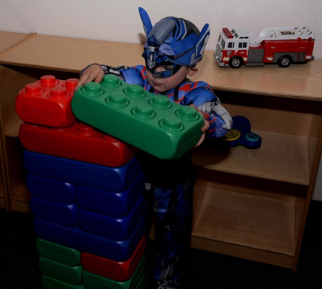 A Travis youth plays with blocks during the Annual Exceptional Family Member Program Halloween Bash at Travis Air Force Base, Calif., Oct. 14, 2016. The event provided a safe atmosphere for special needs families to enjoy Halloween festivities. Approximately 100 people attended the event, which included trick-or-treating, pumpkin decorating, movies and games. (U.S. Air Force photo by Tech. Sgt. James Hodgman)