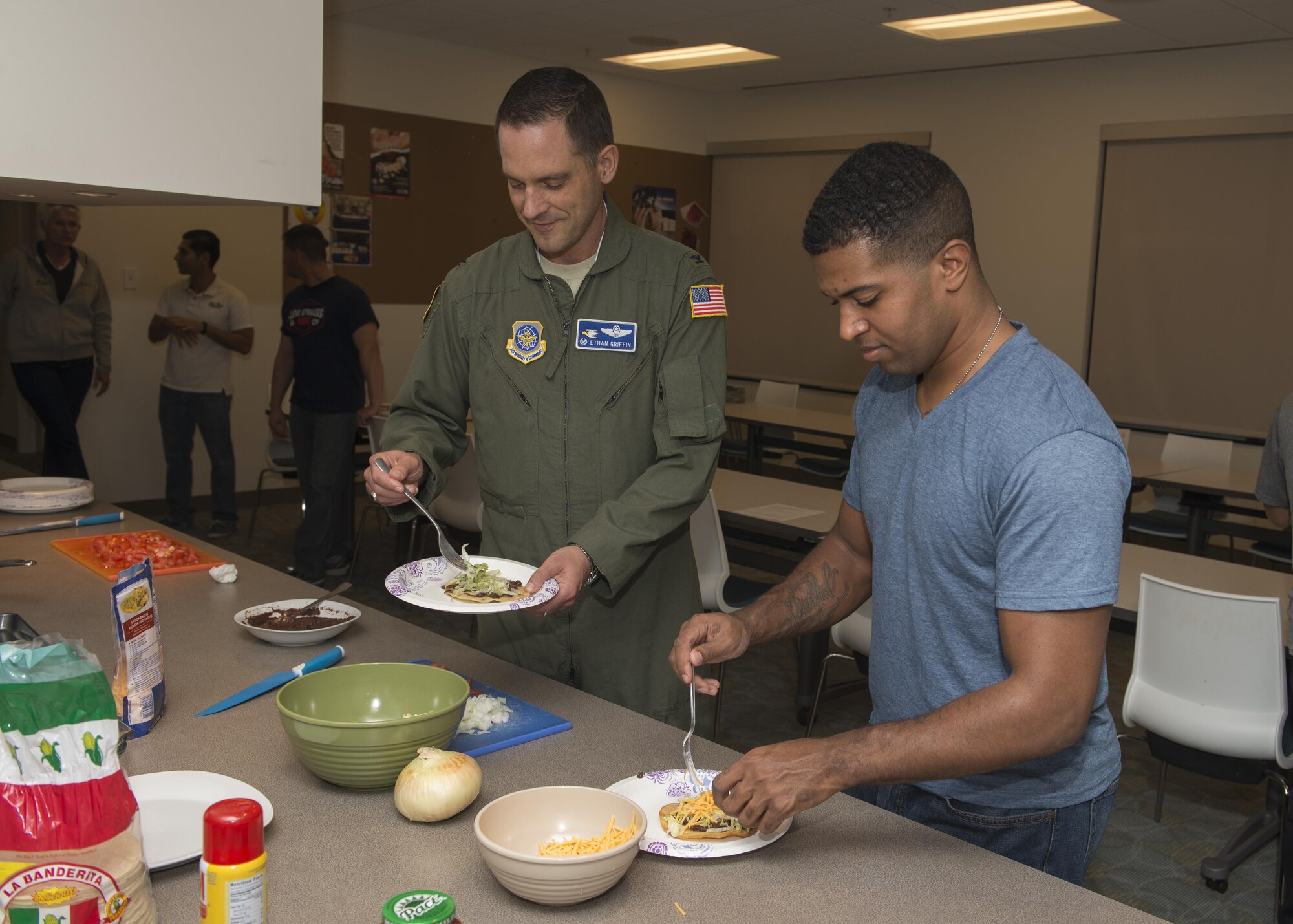 Col. Ethan Griffin, 436th Airlift Wing commander, and Airman 1st Class Shaughn Quarles, 436th Aerial Port Squadron passenger service representative, build themselves black bean tostadas during a Dorm to Gourm class Oct. 11, 2016, inside the fitness center on Dover Air Force Base, Del. Dorm to Gourm is taught monthly with the purpose to educate Airmen who live in the dorms how to cook themselves healthy and easy meals. (U.S. Air Force photo by Senior Airman Zachary Cacicia)