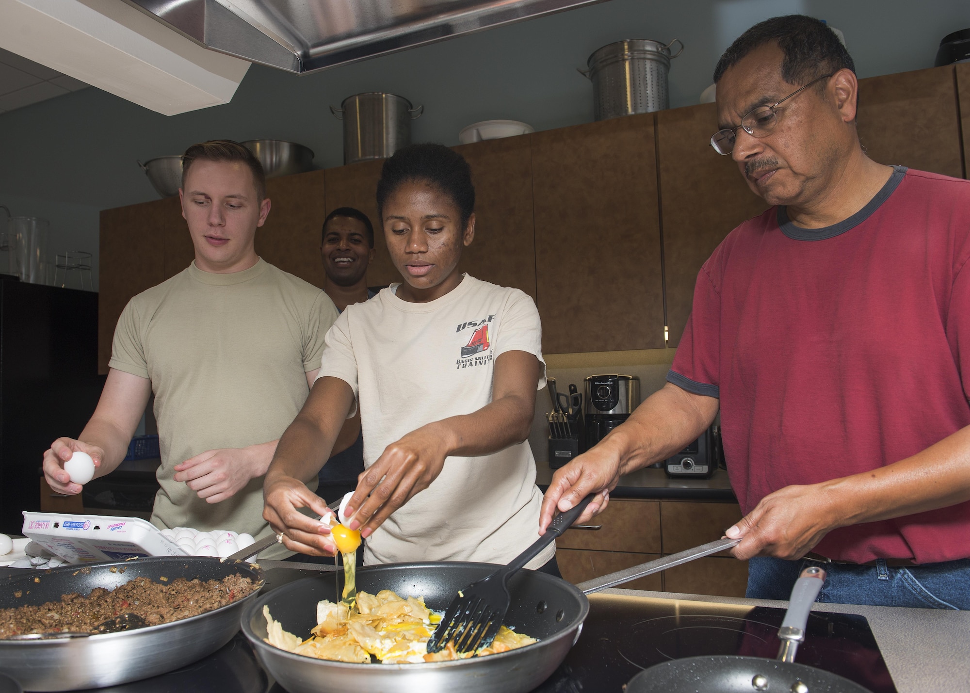 Airman 1st Class Monique Lozano, 436th Aerial Port Squadron cracks an egg into a pan during a Dorm to Gourm class Oct. 11, 2016, inside the fitness center on Dover Air Force Base, Del. Roland Balik, 436th Airlift Wing Public Affairs photojournalist, taught the students how to make beef enchiladas, black bean tostadas and migas. (U.S. Air Force photo by Senior Airman Zachary Cacicia)