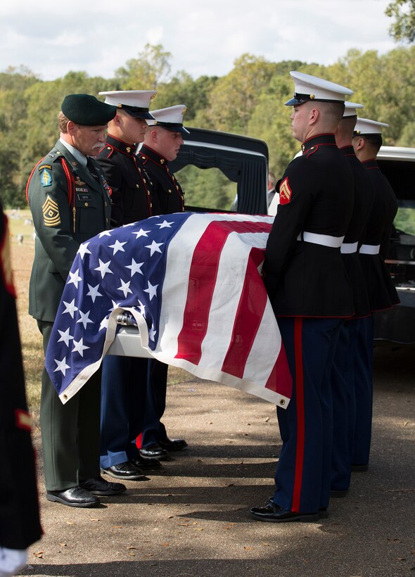 Lane Boler and Ronnie Taylor, view the casket holding the physical remains, uniform, and photo of Pfc. James Samuel Smith during a funeral held at Brown Funeral Home in Liberty, Miss., Oct. 17, 2016.  Smith was killed in action on Nov. 20, 1943 on the small island of Betio in the Tarawa Atoll during World War II. Marines from Marine Forces Reserve honored Smith with a three-round volley and presentation of a folded flag to his next of kin during the burial of his remains.