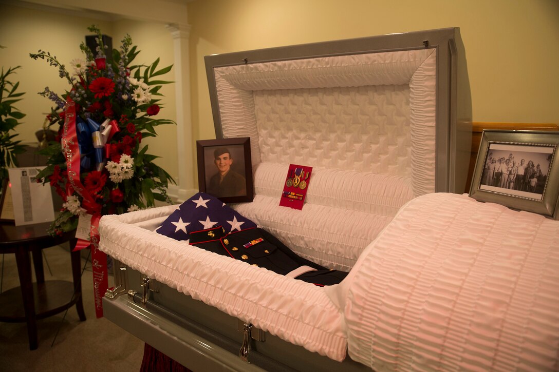 Lane Boler and Ronnie Taylor, view the casket holding the physical remains, uniform, and photo of Pfc. James Samuel Smith during a funeral held at Brown Funeral Home in Liberty, Miss., Oct. 17, 2016.  Smith was killed in action on Nov. 20, 1943 on the small island of Betio in the Tarawa Atoll during World War II. Marines from Marine Forces Reserve honored Smith with a three-round volley and presentation of a folded flag to his next of kin during the burial of his remains.