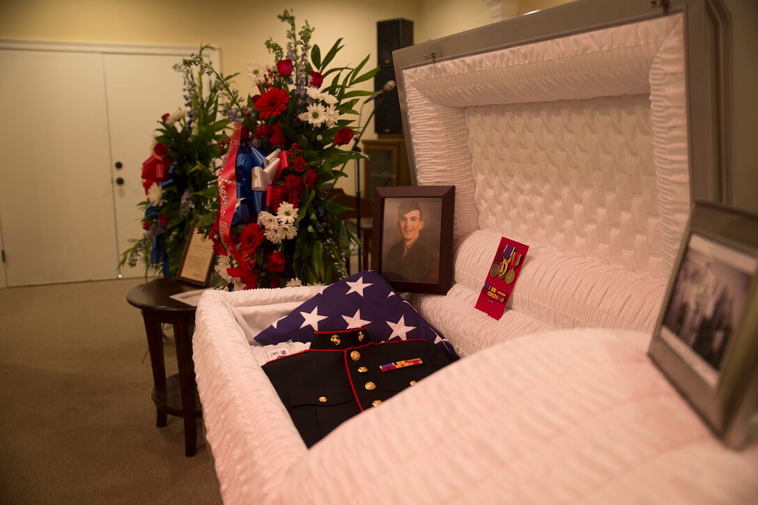 Lane Boler and Ronnie Taylor, view the casket holding the physical remains, uniform, and photo of Pfc. James Samuel Smith during a funeral held at Brown Funeral Home in Liberty, Miss., Oct. 17, 2016.  Smith was killed in action on Nov. 20, 1943 on the small island of Betio in the Tarawa Atoll during World War II. Marines from Marine Forces Reserve honored Smith with a three-round volley and presentation of a folded flag to his next of kin during the burial of his remains.
