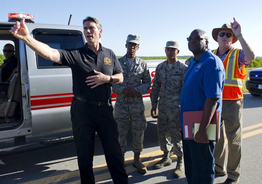 Exercise participants meet during a simulated fuel spill near the 325th Logistics Readiness Squadron fuel depot at Tyndall Air Force Base, Fla., Oct. 13, 2016. During the exercise, Tyndall agencies worked together to mitigate the impact of the simulated fuel spill on the environment. (U.S. Air Force photo by Staff Sgt. Alex Fox Echols III/Released)