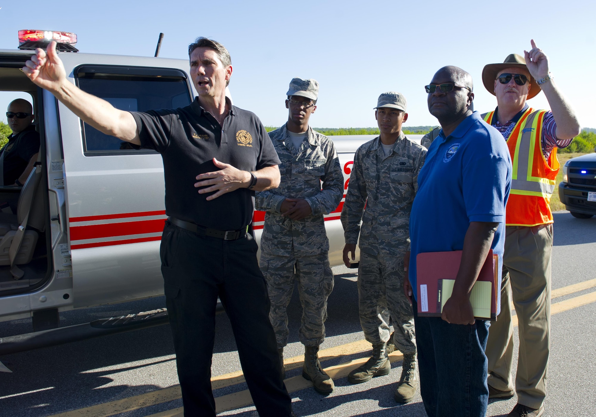 Exercise participants meet during a simulated fuel spill near the 325th Logistics Readiness Squadron fuel depot at Tyndall Air Force Base, Fla., Oct. 13, 2016. During the exercise, Tyndall agencies worked together to mitigate the impact of the simulated fuel spill on the environment. (U.S. Air Force photo by Staff Sgt. Alex Fox Echols III/Released)