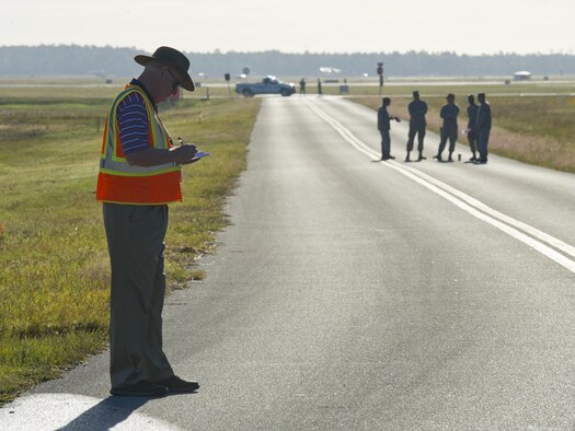 Tracy Taylor, Defense Logistics Agency Energy instructor, takes notes during a fuel spill exercise near the 325th Logistics Readiness Squadron fuel depot at Tyndall Air Force Base, Fla., Oct. 13, 2016. The Defense Logistics Agency is an organization that goes to various installations to oversee these types of exercises to ensure squadrons like the 325th LRS adhere to federal regulations. (U.S. Air Force photo by Staff Sgt. Alex Fox Echols III/Released)