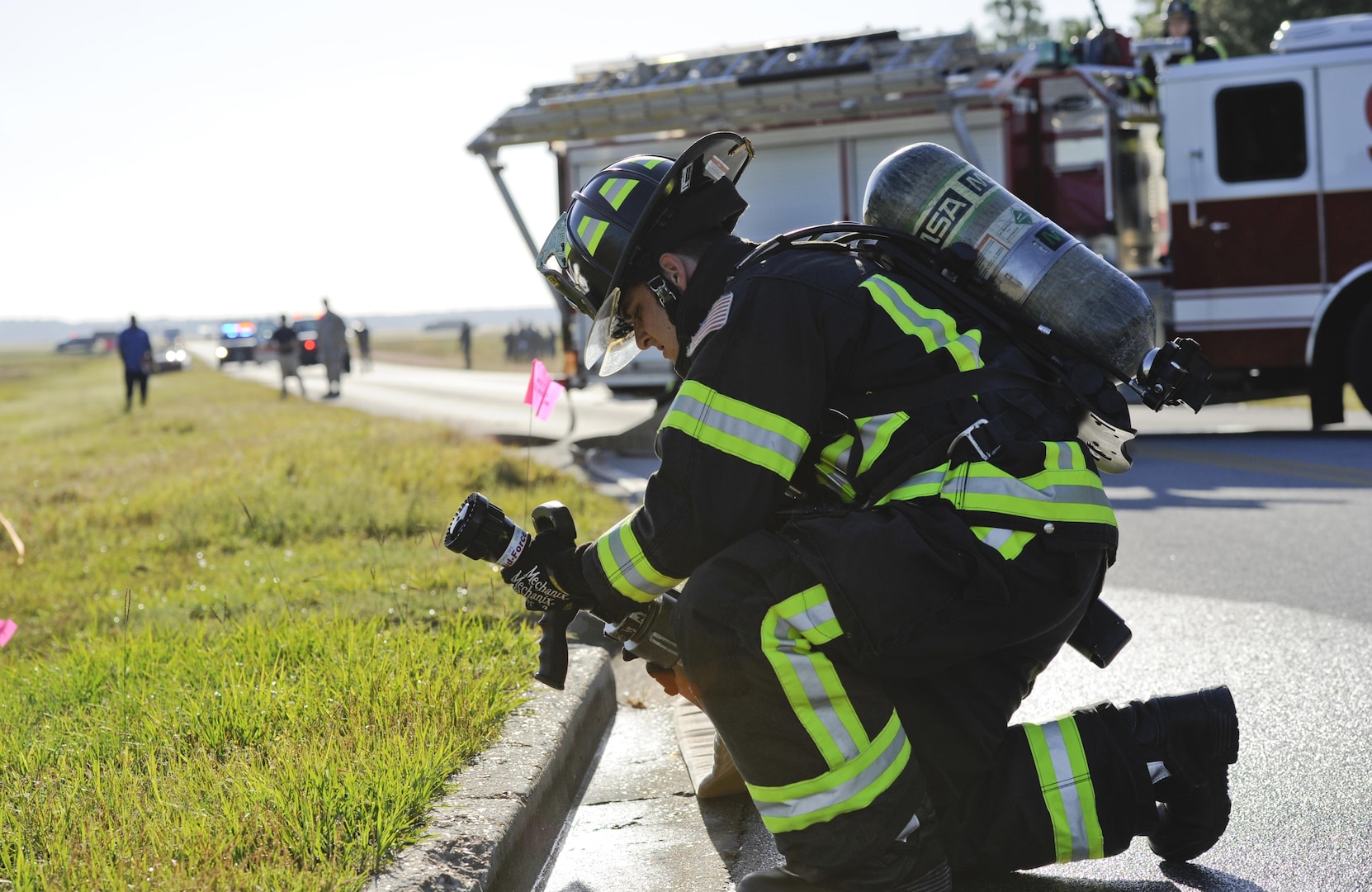 U.S. Air Force Senior Airman Cody Gadsbyhull, 325th Civil Engineer Squadron fire protection specialist, places a fire hose in a drainage ditch during a fuel spill exercise near the 325th Logistics Readiness Squadron fuel depot at Tyndall Air Force Base, Fla., Oct. 13, 2016. The purpose of the exercise was to train Airmen to respond to a simulated fuel spill in a safe and controlled environment. (U.S. Air Force photo by Senior Airman Solomon Cook/Released)  