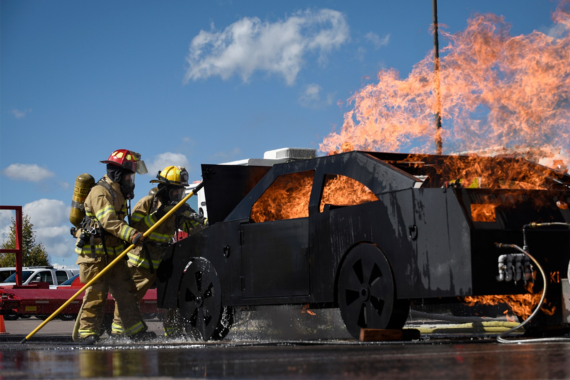PETERSON AIR FORCE BASE, Colo. – Firefighters from Peterson Fire and Emergency Services put out a car fire during a demonstration at the base exchange on Peterson Air Force Base, Colo., Oct. 11, 2016. It was one of many events held throughout National Fire Prevention Week to educate the base populace about the importance of fire safety. (U.S. Air Force photo by Senior Airman Rose Gudex)