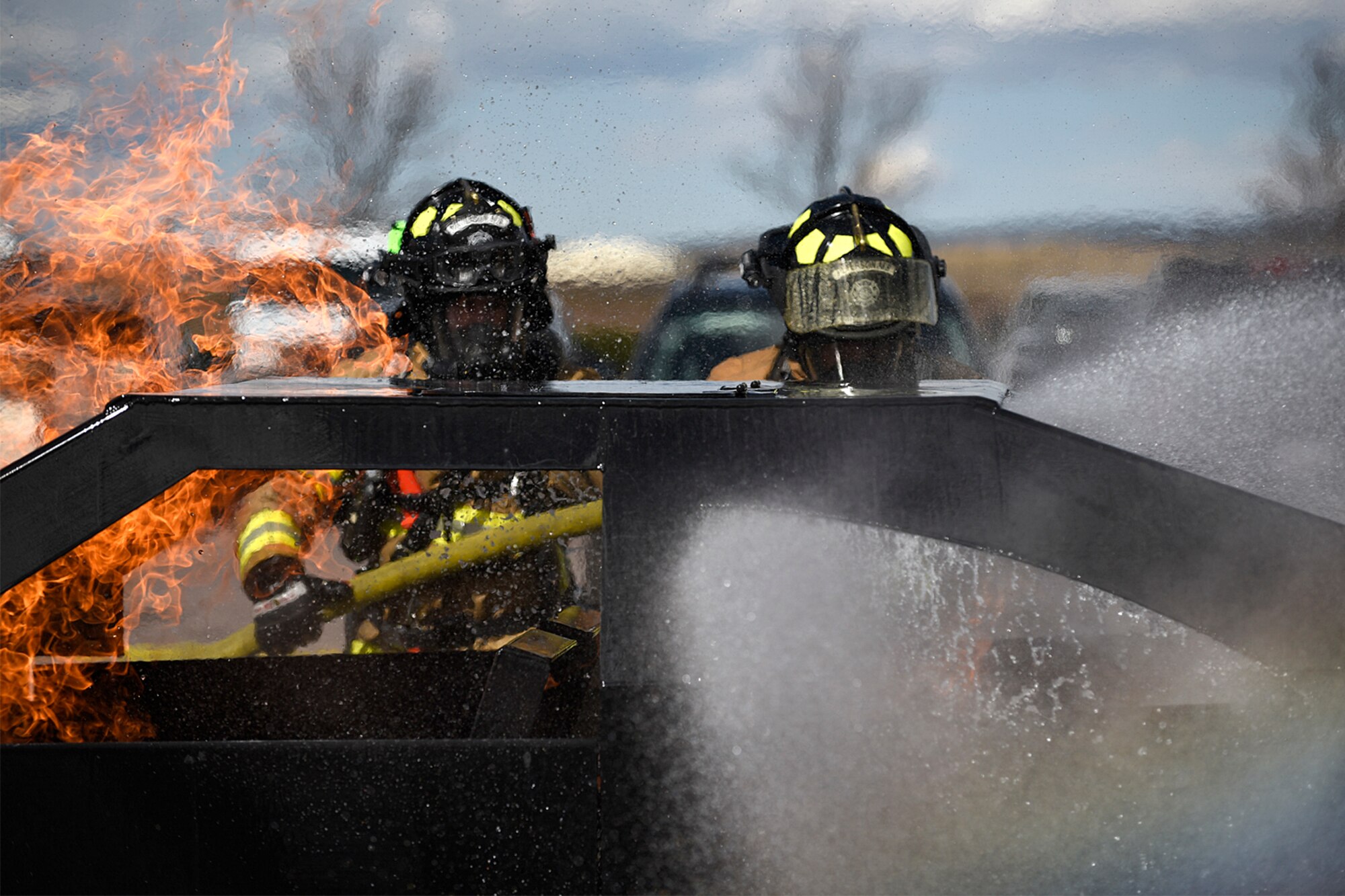 PETERSON AIR FORCE BASE, Colo. – Firefighters from Peterson Fire and Emergency Services put out a car fire during a demonstration at the base exchange on Peterson Air Force Base, Colo., Oct. 11, 2016. It was one of many events held throughout National Fire Prevention Week to educate the base populace about the importance of fire safety. (U.S. Air Force photo by Senior Airman Rose Gudex)