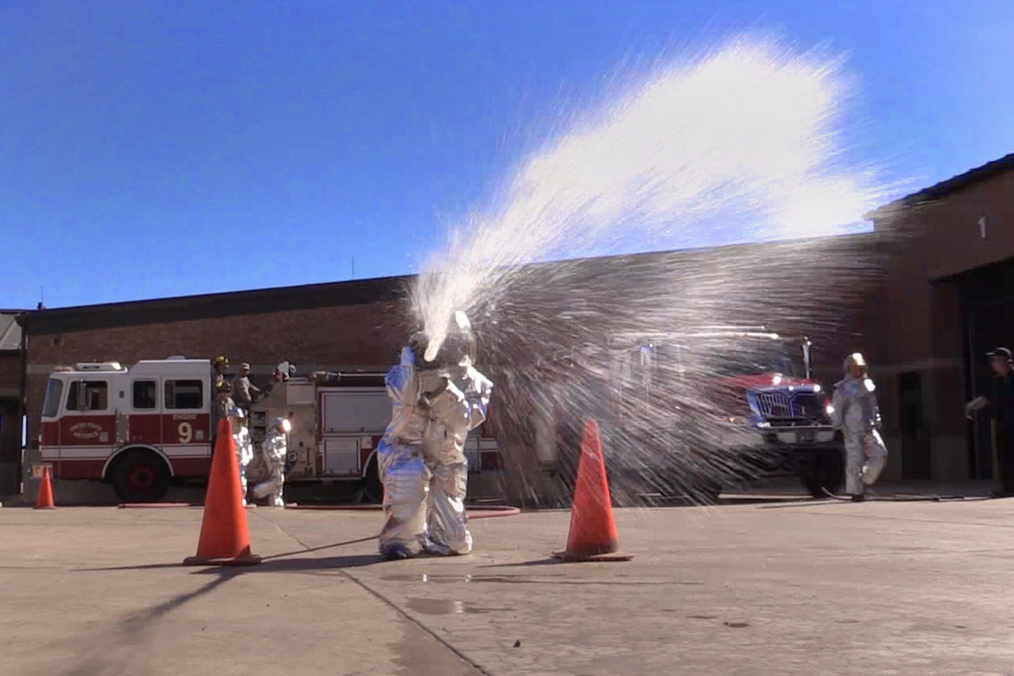 PETERSON AIR FORCE BASE, Colo. – A Peterson Airman takes aim and sprays a target during the Fire Muster at the Fire Station on Peterson Air Force Base, Colo., Oct. 13, 2016. The Fire Muster was a timed event held during National Fire Prevention Week where teams of four competed in six events to get a feel for what firefighters do on a daily basis. (U.S. Air Force photo by Tech. Sgt. Joshua Arends)