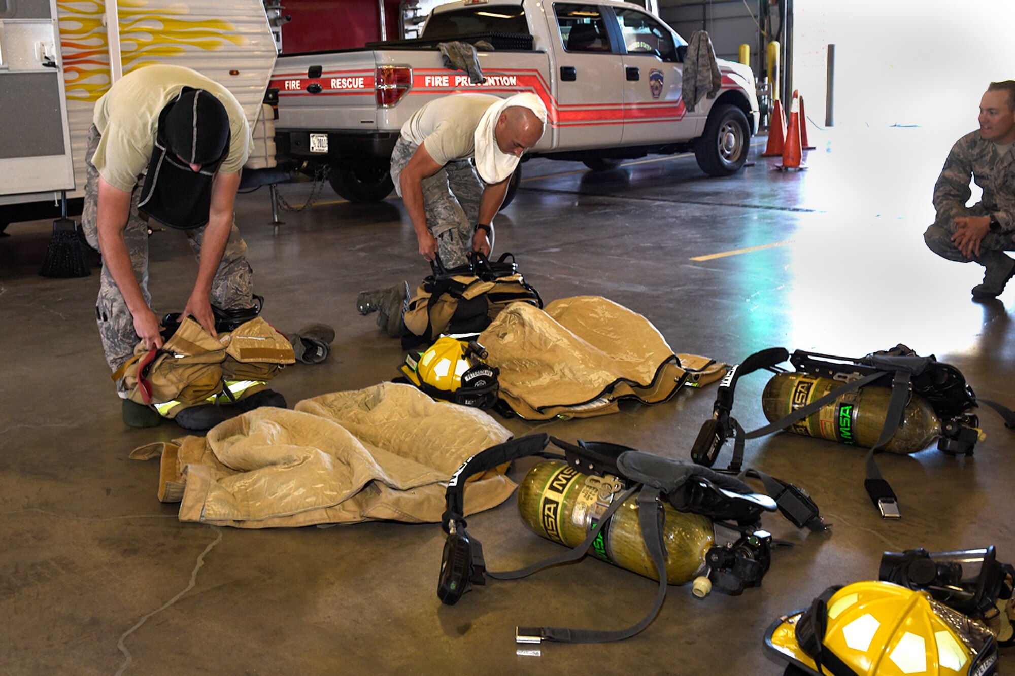 PETERSON AIR FORCE BASE, Colo. – Peterson Fire and Emergency Services firefighters compete in a “bunker drill” to see who can don gear the fastest during an open house at the fire station on Peterson Air Force Base, Colo., Oct. 15, 2016. The open house wrapped up events held by the fire prevention office throughout National Fire Prevention Week, Oct. 10-15. (U.S. Air Force photo by Senior Airman Rose Gudex)