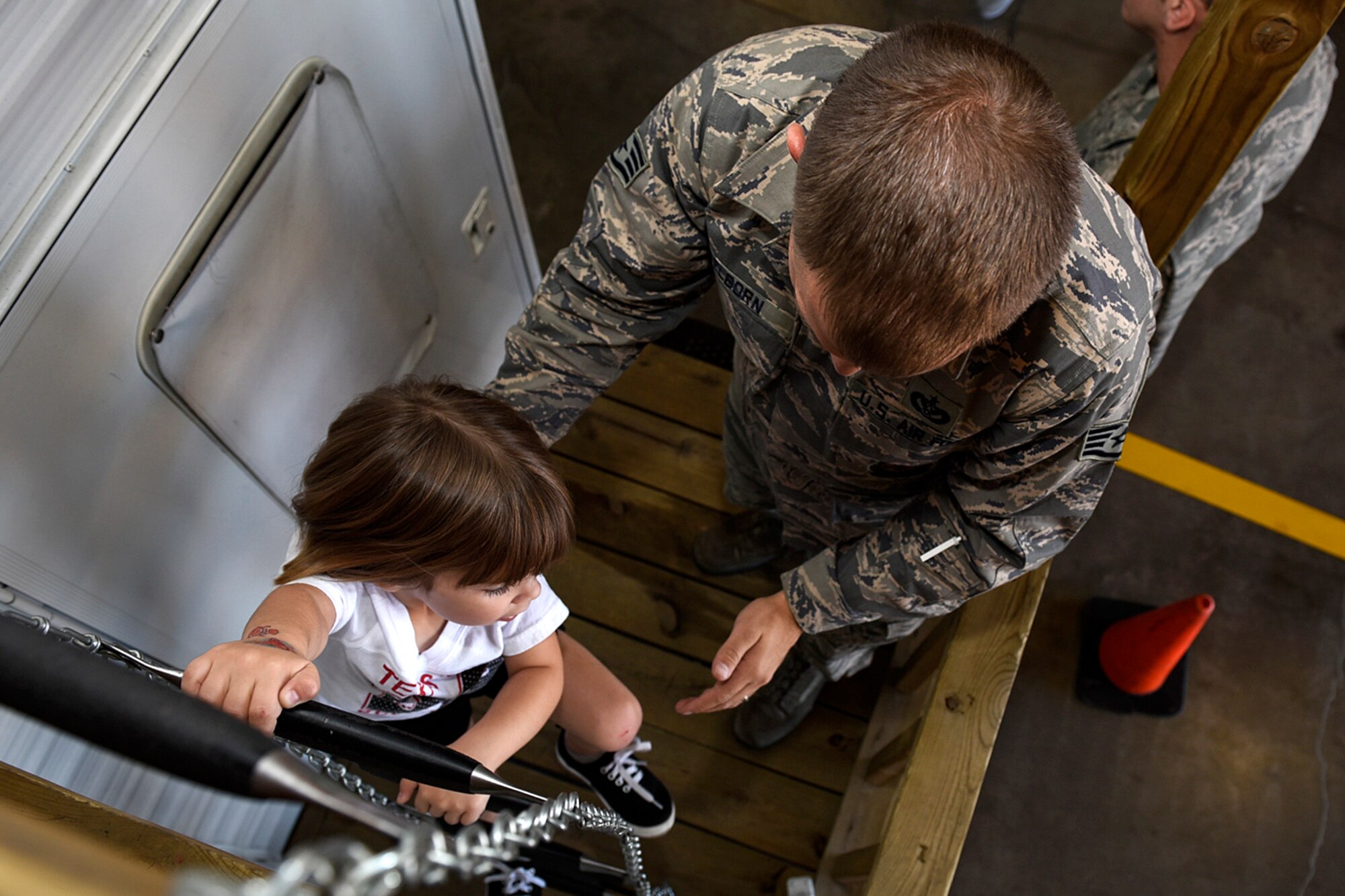 PETERSON AIR FORCE BASE, Colo. – Ella Wilson gets help from a firefighter as she climbs down an escape ladder on the fire safety house at the fire station on Peterson Air Force Base, Colo., Oct. 15, 2016. This was part of the open house at the fire station to wrap up the events put on by the fire prevention office for National Fire Prevention Week. (U.S. Air Force photo by Senior Airman Rose Gudex)