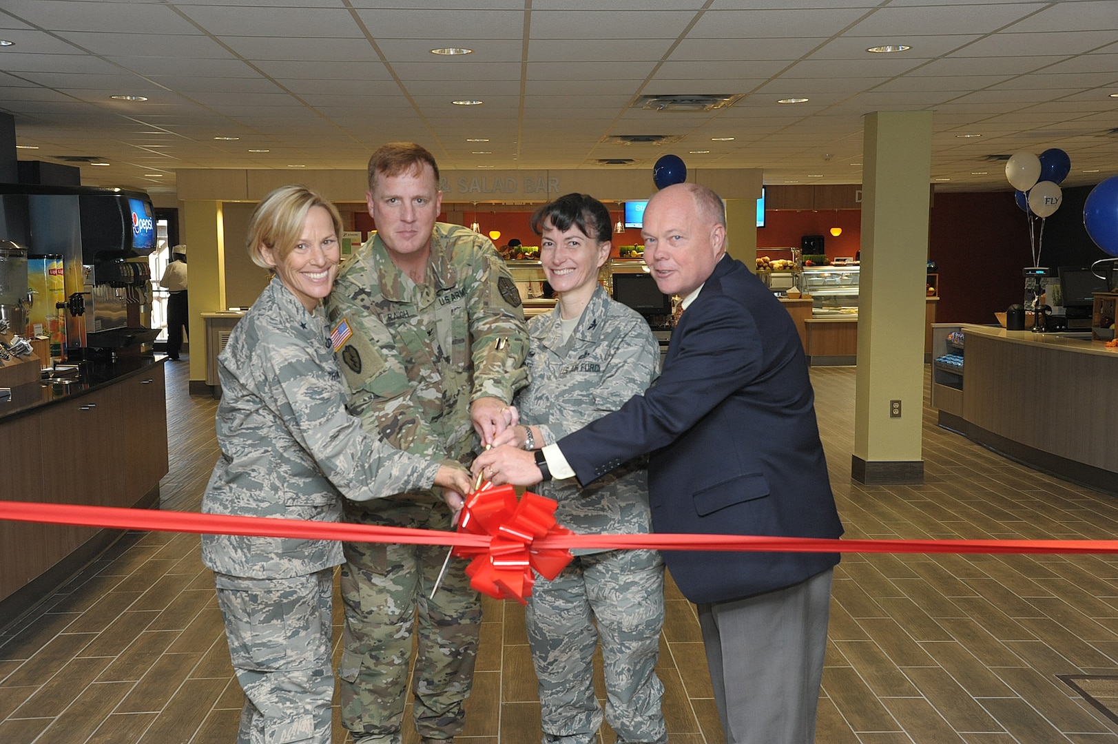 From left: Brig, Gen Heather Pringle, 502nd Air Base Wing and Joint Base San Antonio commander; Col. David Raugh, 502nd Force Support Group commander; Col. Donna Turner, Air Force Services Activity commander; and Brett Ladd, Sodexo vice president of operations, cut the ribbon to the Wingman Café Dining Facility Oct. 11 during the grand-opening ceremony at JBSA-Randolph. Joint Base San Antonio-Randolph’s dining facility, or DFAC, which had been closed for renovation since June 2015, reopened last week with a new name, a new look, more food choices and an expanded customer base.