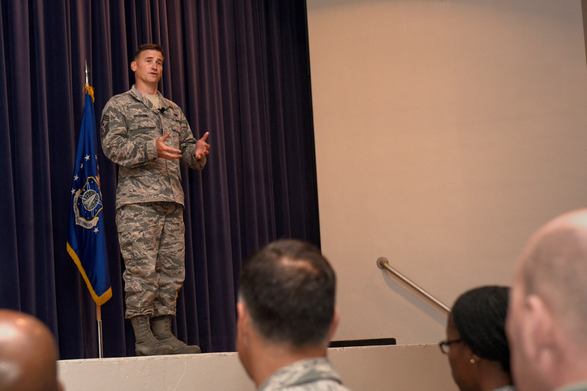 PETERSON AIR FORCE BASE, Colo. – Chief Master Sgt. Mark Bronson, 21st Space Wing command chief, officially introduces himself to Team Pete as the new command chief during the wing commander’s call at the auditorium on Peterson Air Force Base, Colo., Oct. 13, 2016. Bronson said the four most important things to him are faith, family, fitness and fun. (U.S. Air Force photo by Senior Airman Rose Gudex)