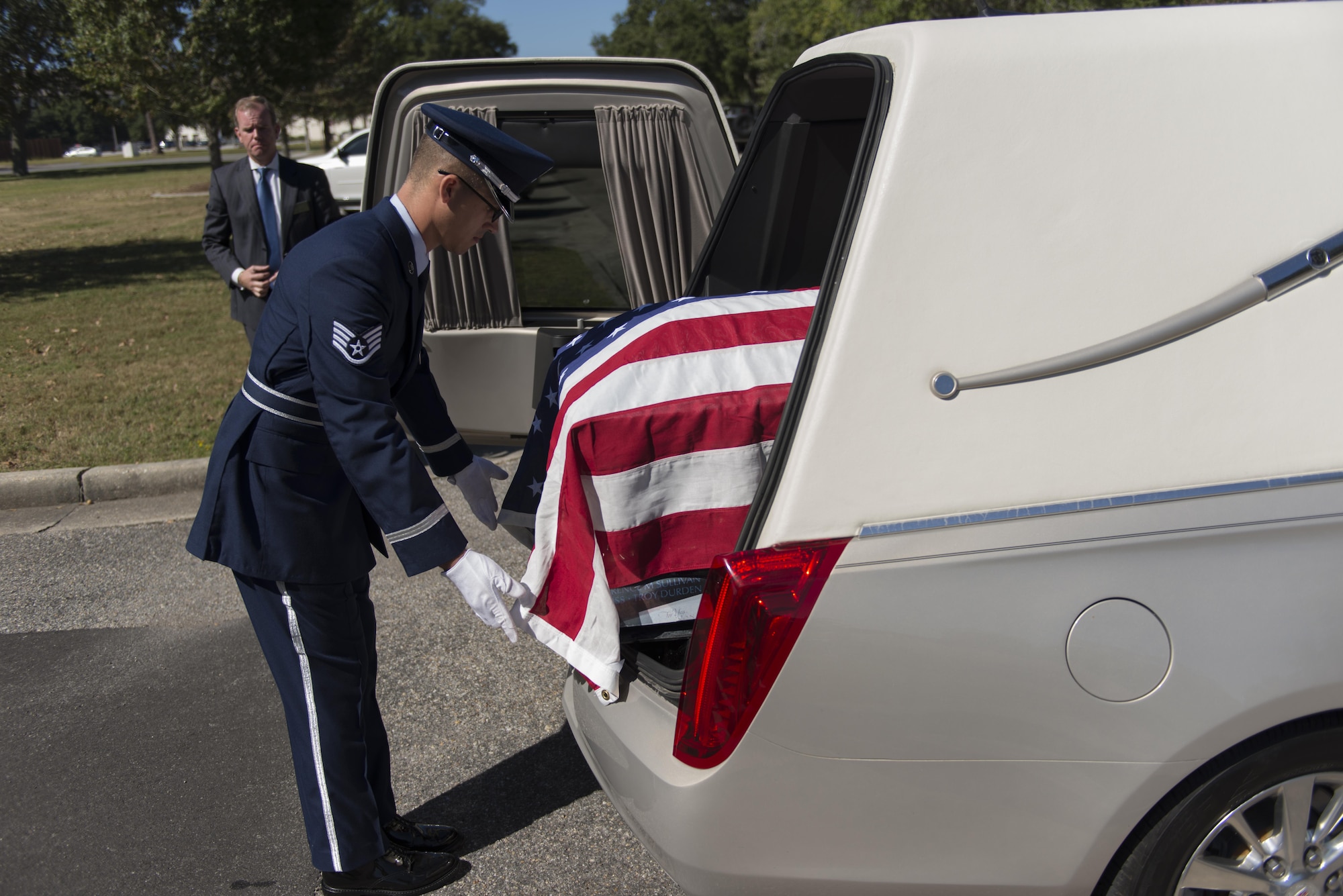 Staff Sgt. Kevin Seney, 335th Training Squadron finance management course instructor, prepares a U.S. flag draped casket during a mock active duty funeral Oct. 12, 2016, on Keesler Air Force Base, Miss. Keesler Honor Guard members were trained on the proper wear of the ceremonial uniform, firing party, presentation of the colors and pallbearer duties during an eight day course with the Air Force Honor Guard Mobile Training Team. The team ended the training with a mock active duty funeral and graduation ceremony. (U.S. Air Force photo by Andre’ Askew/Released)