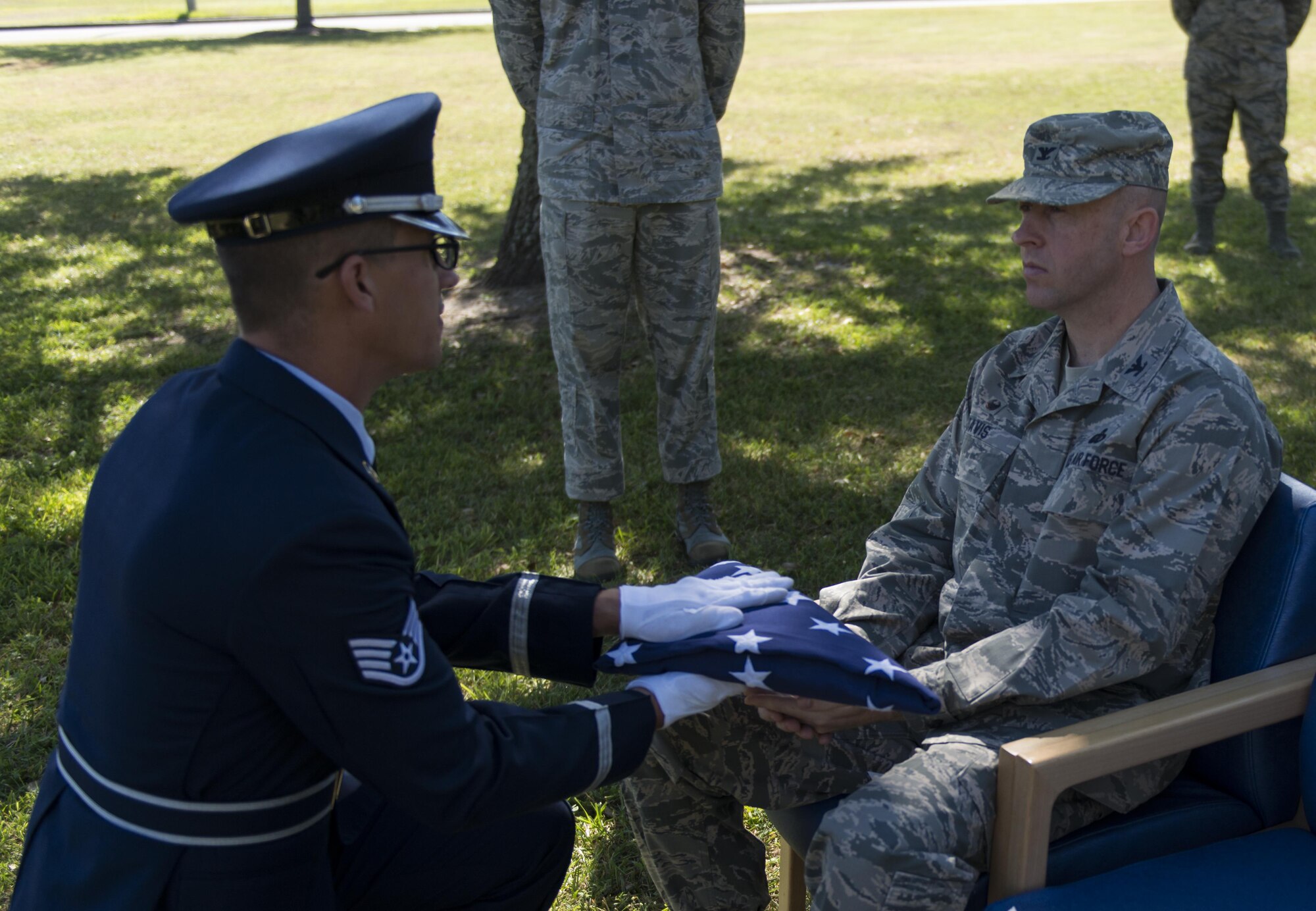 Staff Sgt. Kevin Seney, 335th Training Squadron finance management course instructor, presents the U.S. flag to Col. Danny Davis, 81st Mission Support Group commander, during a mock active duty funeral Oct. 12, 2016, on Keesler Air Force Base, Miss. Keesler Honor Guard members were trained on the proper wear of the ceremonial uniform, firing party, presentation of the colors and pallbearer duties during an eight day course with the Air Force Honor Guard Mobile Training Team. The team ended the training with a mock active duty funeral and graduation ceremony. (U.S. Air Force photo by Andre’ Askew/Released)


