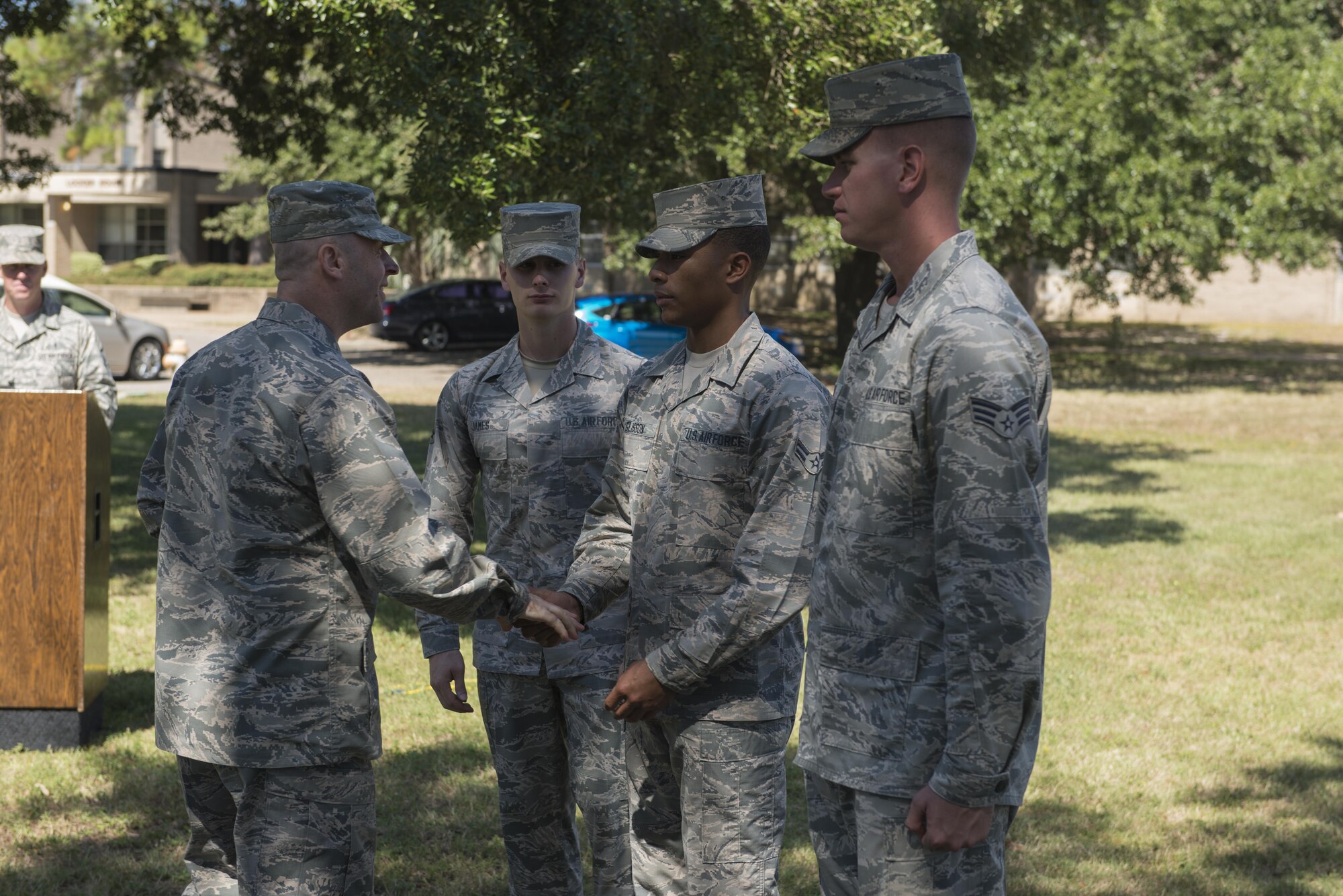 Col. Danny Davis, 81st Mission Support Group commander, presents Airman 1st Class Anthony Glisson, Air Force Honor Guard Mobile Training Team pallbearer instructor, with a unit coin after a mock active duty funeral and graduation ceremony Oct. 12, 2016, on Keesler Air Force Base, Miss. Keesler Honor Guard members were trained on the proper wear of the ceremonial uniform, firing party, presentation of the colors and pallbearer duties during an eight day course with the Air Force Honor Guard Mobile Training Team. The team ended the training with the mock funeral and graduation ceremony. (U.S. Air Force photo by Andre’ Askew/Released)