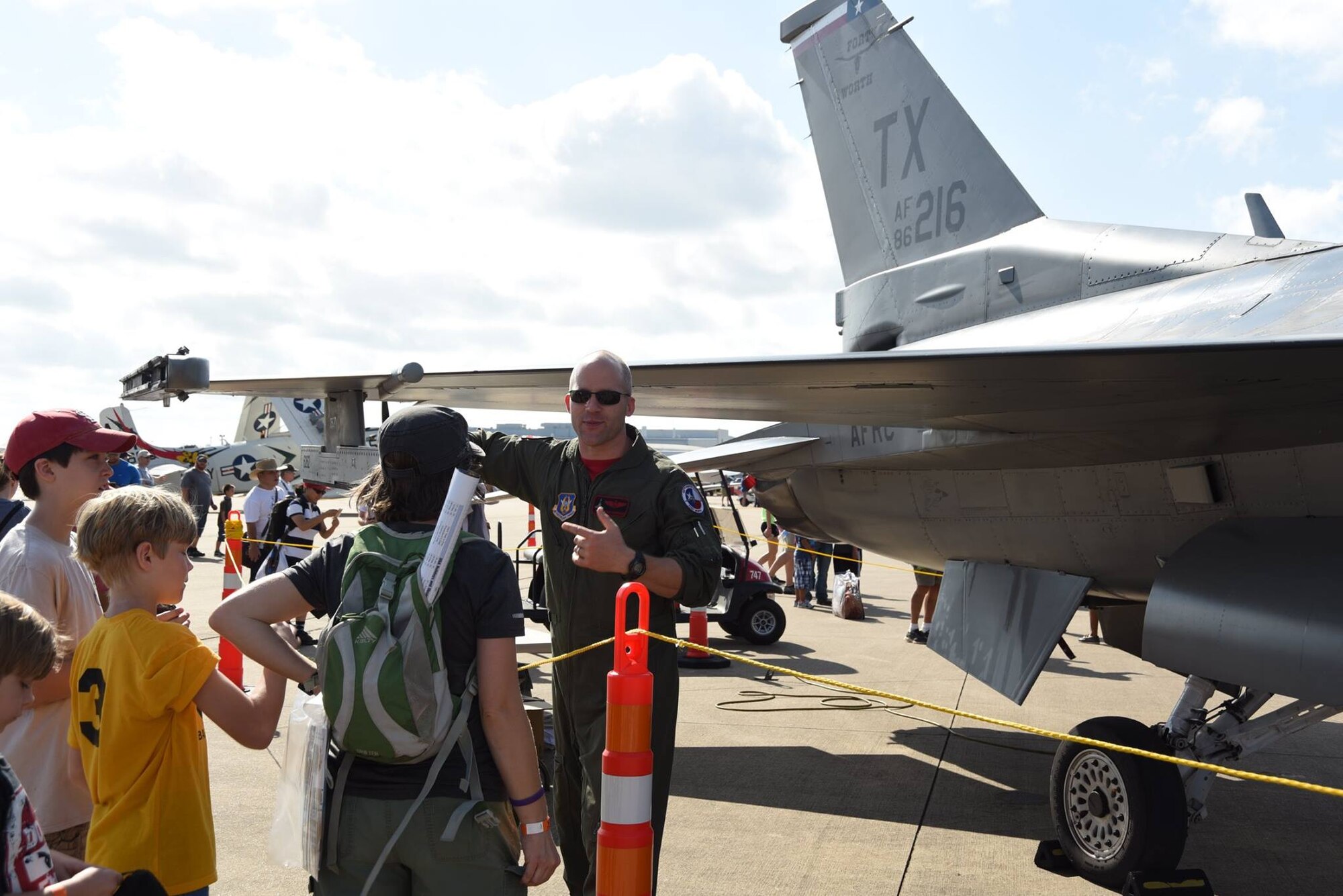 Maj. Daniel “Wasabi” Summers, a 457th Fighter Squadron pilot, from Naval Air Station Fort Worth Joint Reserve Base, Texas visits with attendees at the Bell Helicopter Fort Worth Alliance Air Show, Oct. 15. The show provides the public with an opportunity to learn about military and civilian aviation history. An estimated 65,000 people attended the air show this year. (U.S. Air Force photos by Tech. Sgt. Melissa Harvey)