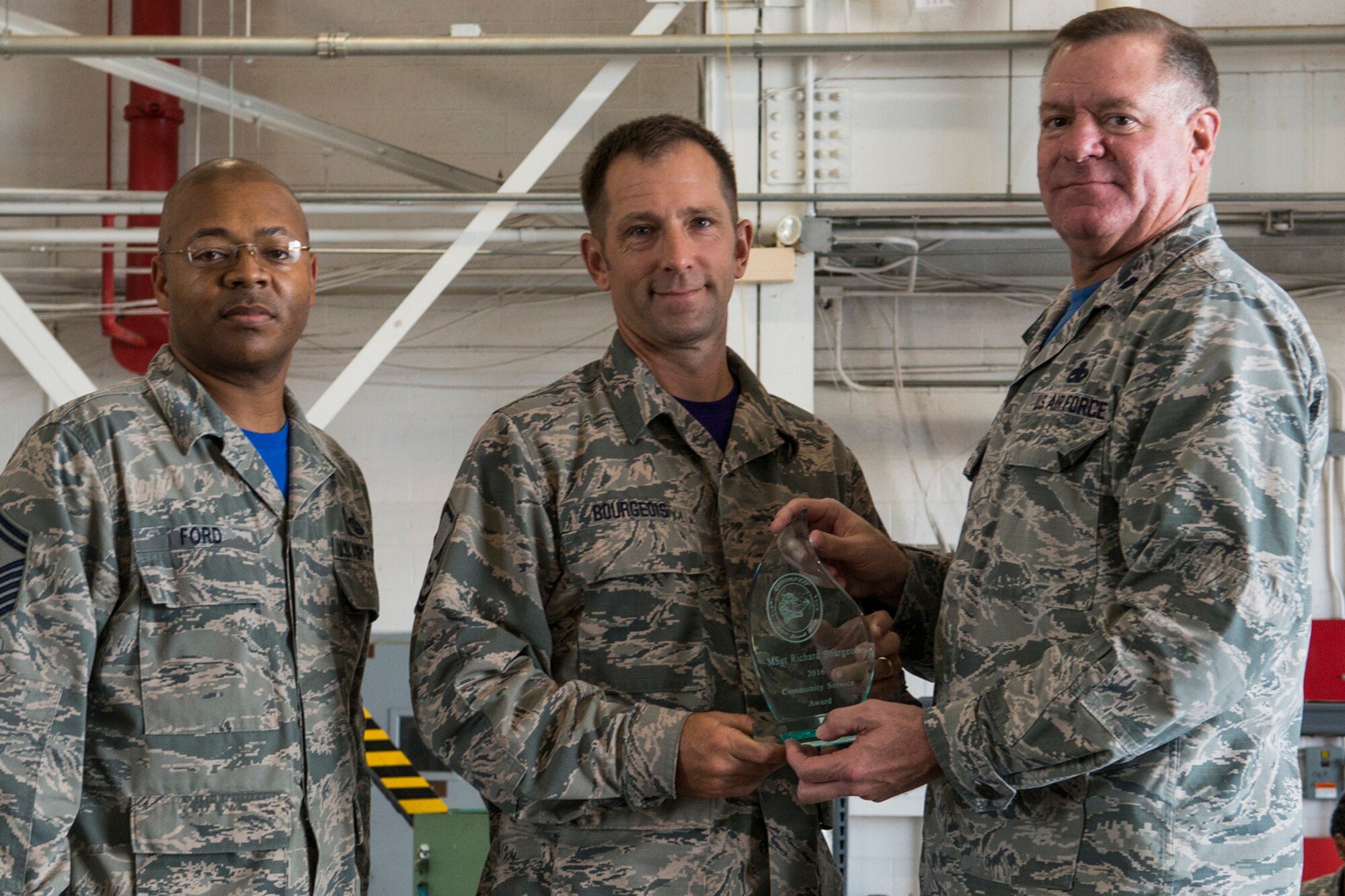 U.S. Air Force Lt. Col. Leo Kamphaus, 307th Maintenance Group commander, presents an award to Master Sgt. Richard Bourgeois during the annual Gatorfest Awards Ceremony on Oct. 15, 2016, Barksdale Air Force Base, La. Bourgeois is the recipient of the Community Service Award. (U.S. Air Force photo by Master Sgt. Greg Steele/Released)