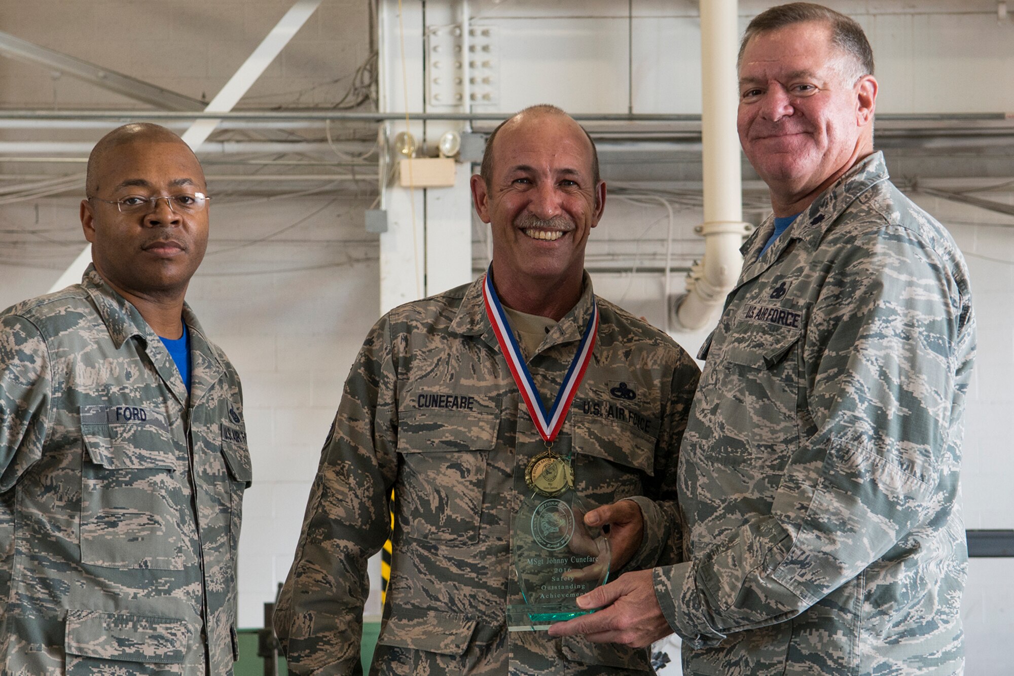U.S. Air Force Lt. Col. Leo Kamphaus, 307th Maintenance Group commander, presents an award to Master Sgt. Johnny Cunefare during the annual Gatorfest Awards Ceremony on Oct. 15, 2016, Barksdale Air Force Base, La. Cunefare is the recipient of the Safety Outstanding Achievement Award. (U.S. Air Force photo by Master Sgt. Greg Steele/Released)