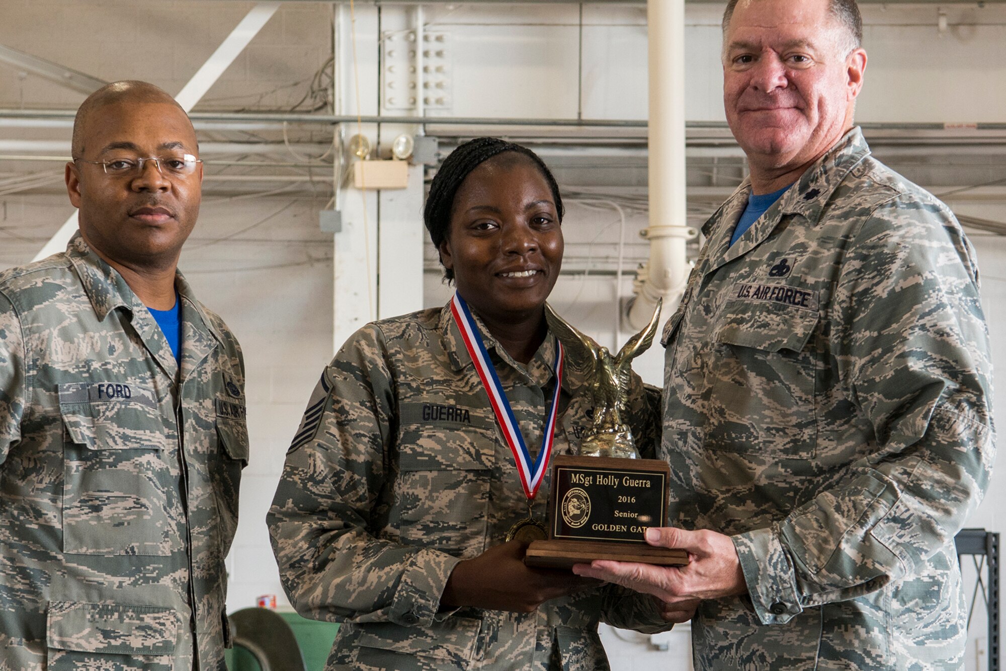 U.S. Air Force Lt. Col. Leo Kamphaus, 307th Maintenance Group commander, presents an award to Master Sgt. Holly Guerra during the annual Gatorfest Awards Ceremony on Oct. 15, 2016, Barksdale Air Force Base, La. Guerra is the recipient of the Senior Golden Gator award. (U.S. Air Force photo by Master Sgt. Greg Steele/Released)