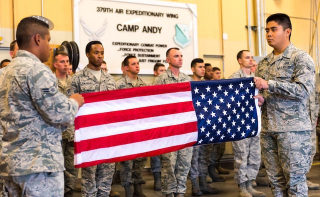 Airmen, assigned to the 366th Civil Engineer Squadron, fold a flag at the annual remembrance ceremony of Master Sgt. Evander Andrews at Mountain Home Air Force Base, Idaho. Andrews was the first casualty in the War on Terror after the attacks on 9/11 when he lost his life while building a runway in Qatar.