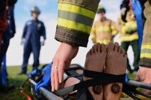 Firefighters from Joint Base Lewis-McChord Fire and Emergency Services prepare a simulated patient for transport during low-angle rescue training Oct. 17, 2016, at Joint Base Lewis-McChord, Wash. The training simulated a rescue from a vehicle rollover down an embankment. (U.S. Air Force photo/Senior Airman Jacob Jimenez)   