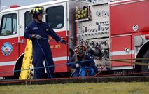 Mike Gehrke (left) and Nicole Cherry, Joint Base Lewis-McChord Fire and Emergency Services firefighters, assist in the transportation of a simulated patient during low-angle rescue training Oct. 17, 2016, at Joint Base Lewis-McChord, Wash. JBLM firefighters train in variety of simulated scenarios annually to ensure proficiency in their gear and requirements. (U.S. Air Force photo/Senior Airman Jacob Jimenez)         