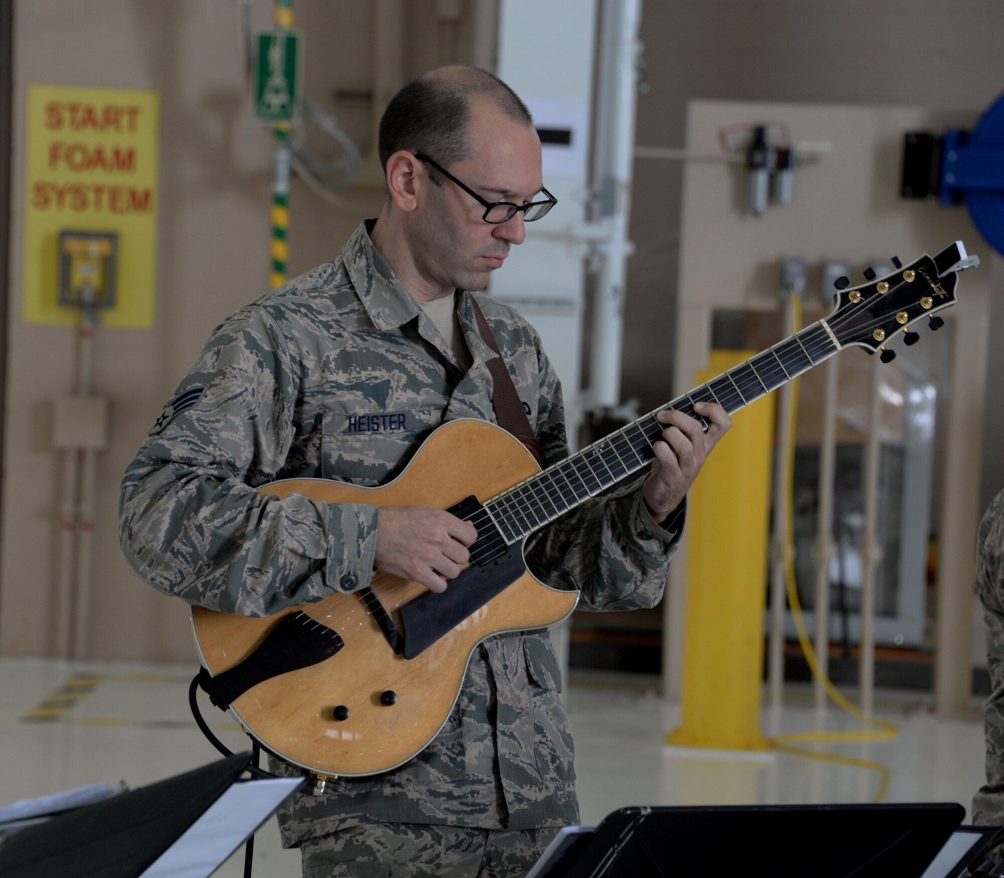 Senior Airman Matthew Heister, U.S. Air Force Band of the Golden West guitarist, plays the guitar during a performance at the 21st annual Retiree Appreciation Day event at Travis Air Force Base, Calif., Oct. 15, 2016. More than 100 veterans and their families attended the event, which was held to honor the service and sacrafice of military veterans. (U.S. Air Force photo by Tech. Sgt. James Hodgman)