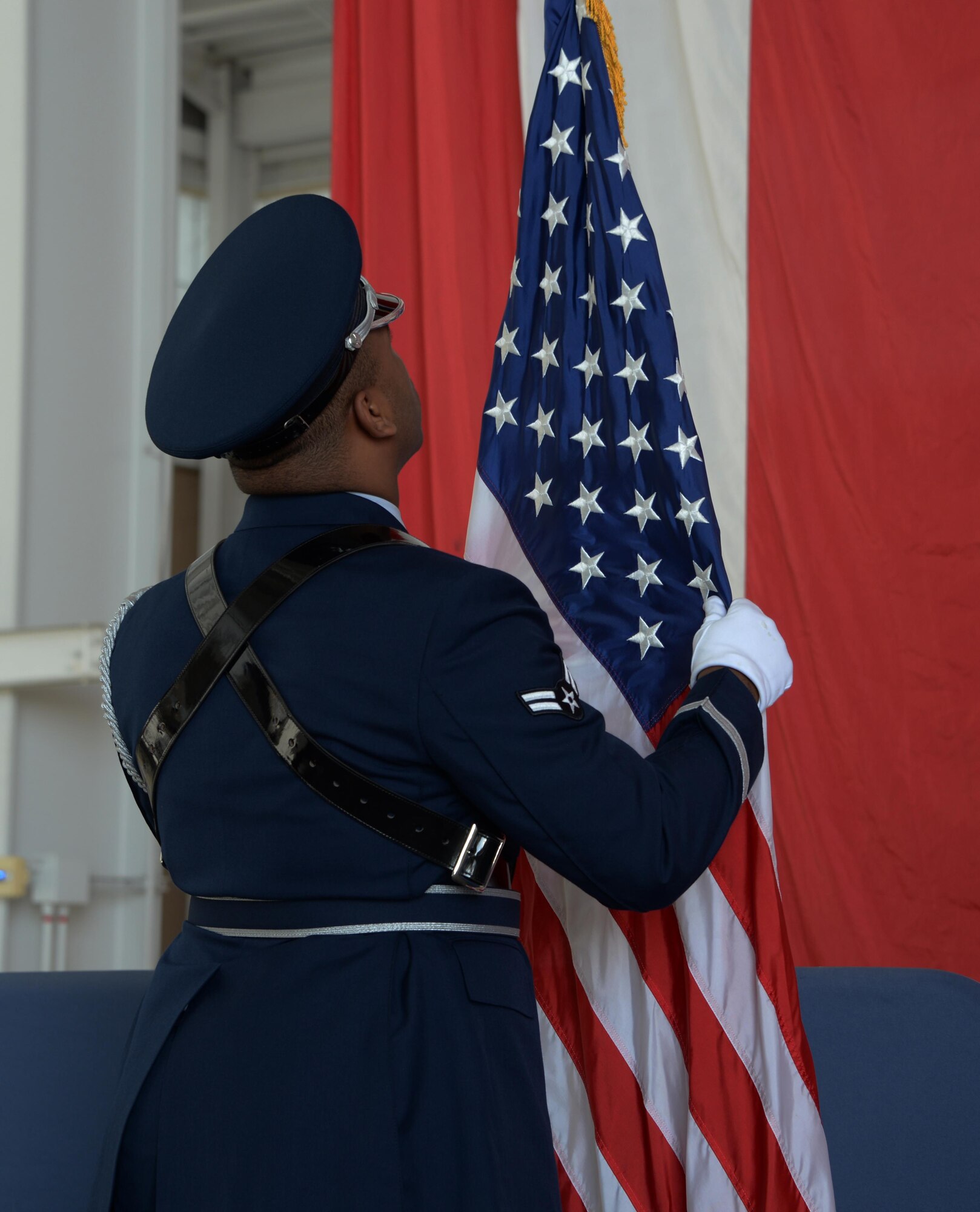 A member of the Travis Air Force Base Honor Guard ensures the U.S. flag is properly displayed during a posting of the colors ceremony at the 21st annual Retiree Appreciation Day event at TAFB, California, Oct. 15, 2016. The event was held to honor the service and sacrifice of military veterans. More than 100 retired servicemembers attended. (U.S. Air Force photo by Tech. Sgt. James Hodgman)