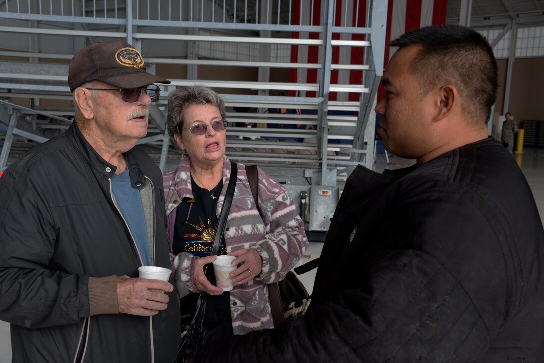Tech. Sgt. Francis San Luis, 60th Security Forces Squadron kennel master, speaks with military veterans during the 21st annual Retiree Appreciation Day event at Travis Air Force Base, Calif., Oct. 15, 2016. The event was held to honor the service and sacrifice of military veterans. (U.S. Air Force photo by Tech. Sgt. James Hodgman)