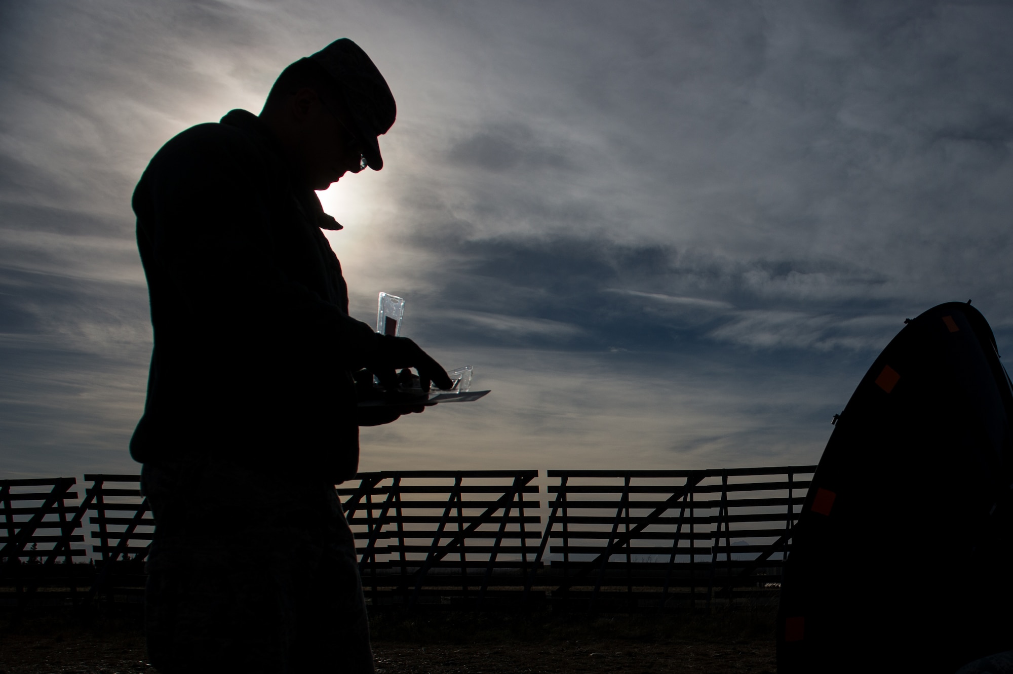 U.S. Air Force Senior Adam Schenk, 621st Contingency Response Support Squadron checks the compass reading while adjusting a satellite dish during exercise RED FLAG-Alaska 17-1 at Fort Greely, Alaska, Oct. 11, 2016. RF-A is a series of Pacific Air Forces commander-directed field training exercises for U.S. and partner nation forces, providing combined offensive counter-air, interdiction, close air support, and large force employment training in a simulated combat environment. (U.S. Air Force photo by Master Sgt. Joseph Swafford)