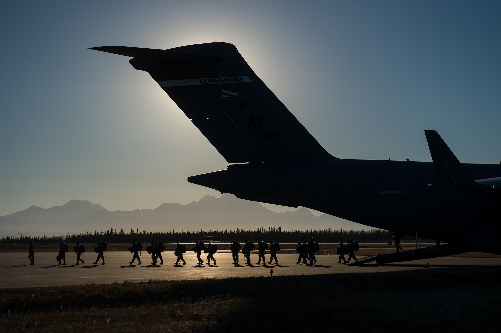 U.S. Airmen assigned to the 621st Contingency Response Wing guide Soldiers with the 4th Brigade Combat Team (Airborne), 25th Infantry Division as they exit a C-17 Globemaster III aircraft during exercise RED FLAG-Alaska 17-1, Oct. 13, 2016. RF-A is a series of Pacific Air Forces commander-directed field training exercises for U.S. and partner nation forces, providing combined offensive counter-air, interdiction, close air support, and large force employment training in a simulated combat environment. (U.S. Air Force photo by Master Sgt. Joseph Swafford)