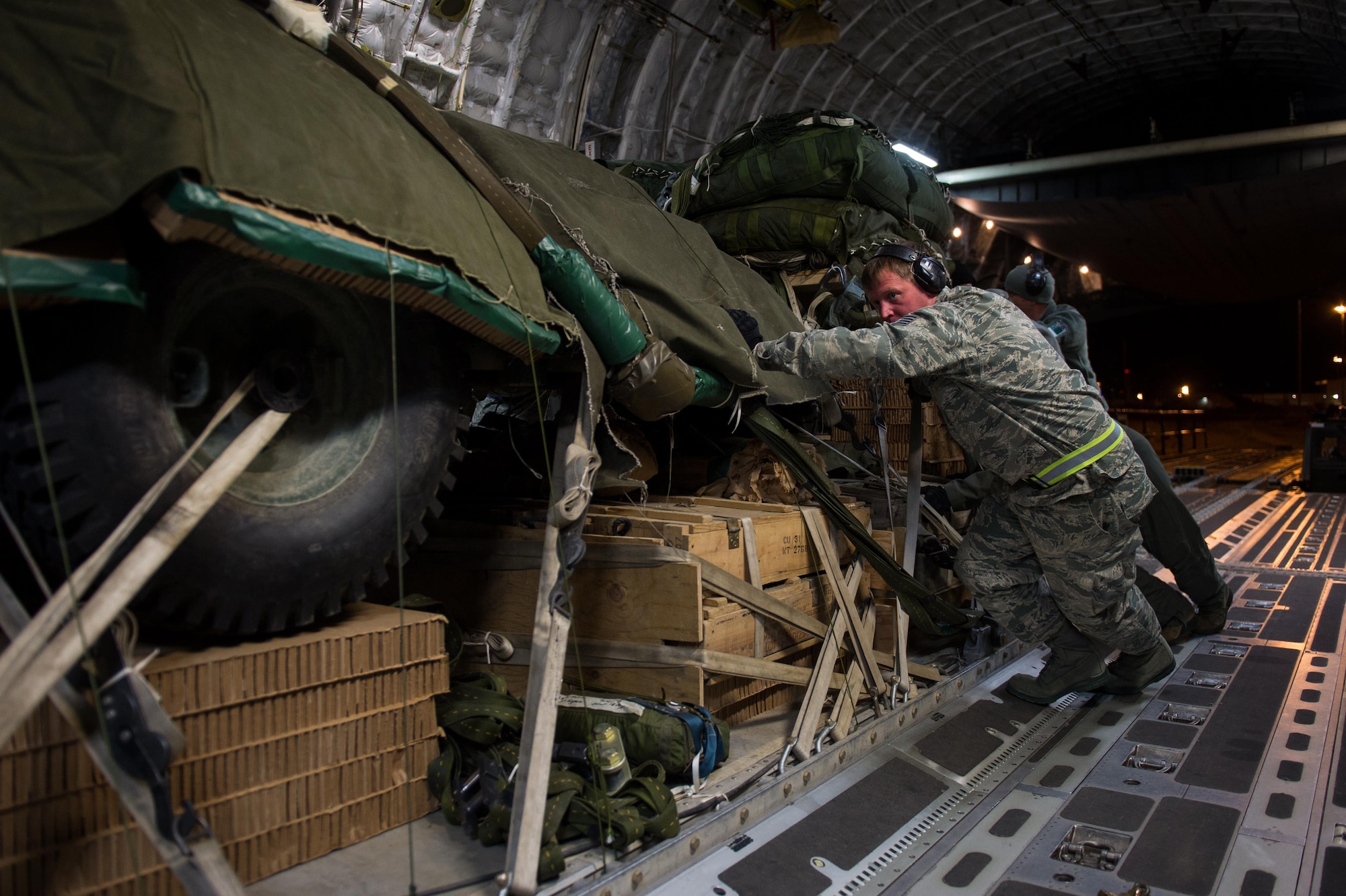 U.S. Air Force Staff Sgt. Andrew Ammerman, 621st Contingency Response Support Squadron aerial port specialist loads a pallet onto a C-17 Globemaster III aircraft during exercise RED FLAG-Alaska at Joint Base Elmendorf-Richardson, Alaska, Oct. 11, 2016. RF-A is a series of Pacific Air Forces commander-directed field training exercises for U.S. and partner nation forces, providing combined offensive counter-air, interdiction, close air support, and large force employment training in a simulated combat environment. (U.S. Air Force photo by Master Sgt. Joseph Swafford)