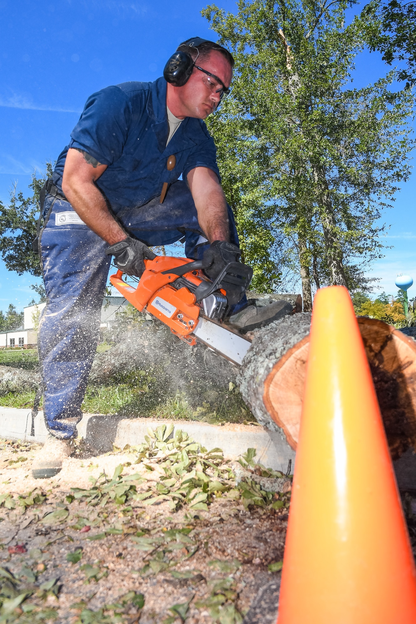 U.S. Air Force Staff Sgt. Jhon Roberts from the 116th Air Control Wing (ACW), Georgia Air National Guard, chain saws a fallen tree during road-clearing operations in the aftermath of Hurricane Matthew, Savannah, Ga., Oct. 10, 2016. Citizen Airmen from the 116th ACW deployed to Savannah to support civil authorities working along side the Chatham County Public Works department to assist in road clearing and debris cleanup operations. (U.S. Air National Guard photo by Senior Master Sgt. Roger Parsons)