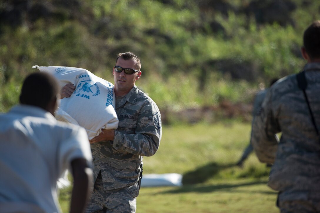 U.S. Air Force Master Sgt. Gabriel Peterson, with the 290th Joint Communications Support Element, delivers cooking supplies to citizens of Beaumont, Haiti, Oct. 13, 2016. Peterson is part of Joint Task Force Matthew, which has delivered more than 440 tons of supplies to Haitian citizens affected by Hurricane Matthew. (U.S. Air Force Photo by Tech. Sgt. Russ Scalf)
