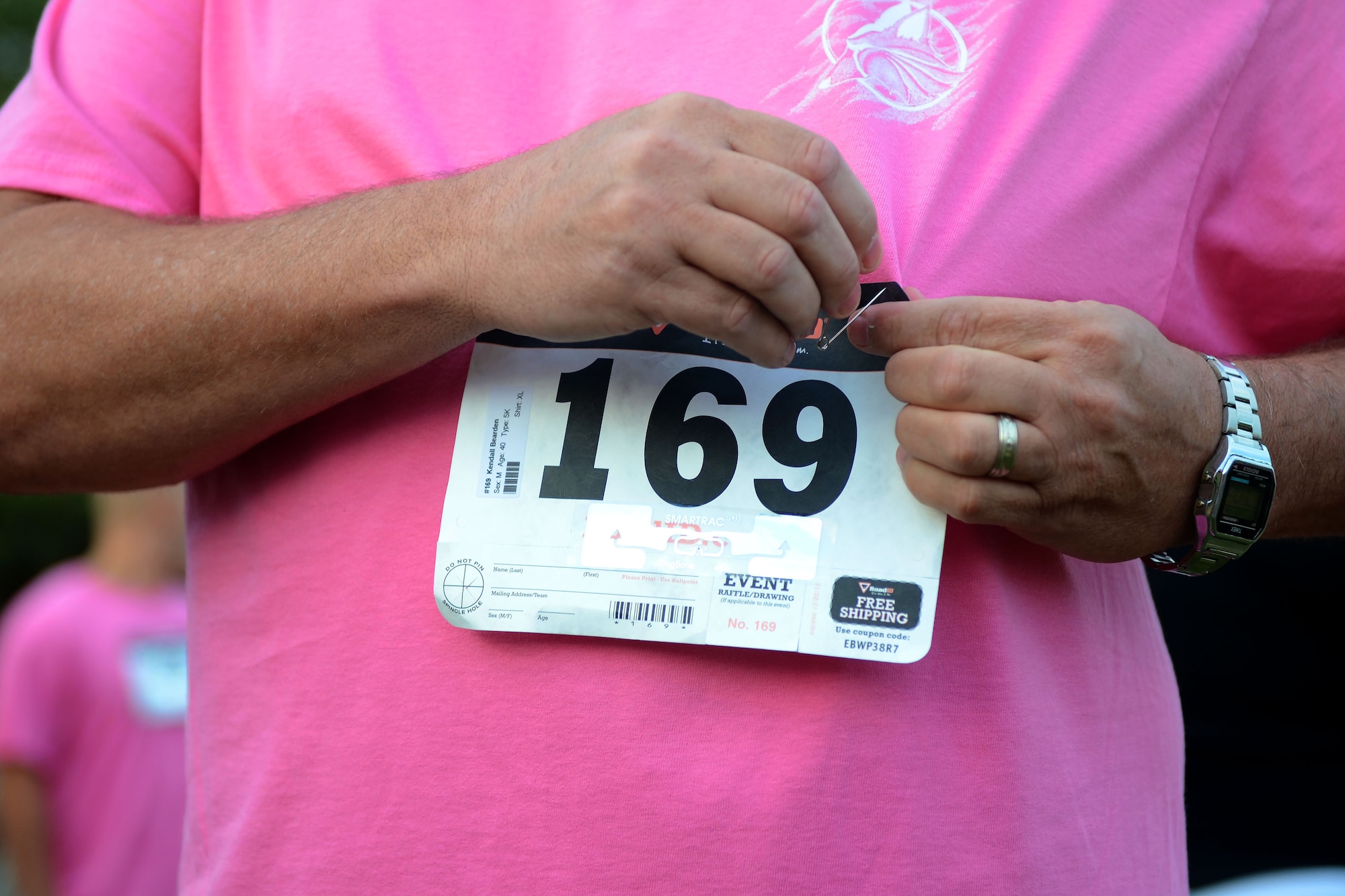 U.S. Air Force Tech. Sgt. Kendall Bearden, a power production specialist assigned to the 169th Civil Engineering Squadron, fastens his number to his shirt before the 6th annual Foxtrot Warrior Run at McEntire Joint National Guard Base, S.C., Oct. 16, 2016.  The fundraiser event raised money for the Warm Heart Association to benefit Airman 1st Class Jamia Porcher, an aircraft electrician assigned to the 169th Maintenance Squadron, and other South Carolina Wounded Warrior charities.  (U.S. Air National Guard photo by Senior Airman Ashleigh Pavelek)  