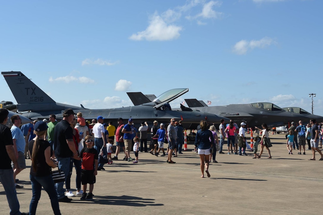 A crowd at the Bell Helicopter Fort Worth Alliance Air Show visit with 457th Fighter Squadron pilots and get an up close look at an F-16 Fighting Falcon from Naval Air Station Fort Worth Joint Reserve Base, Texas, Oct. 15. The show provides the public with an opportunity to learn about military and civilian aviation history. An estimated 65,000 people attended the air show this year. (U.S. Air Force photos by Tech. Sgt. Melissa Harvey)