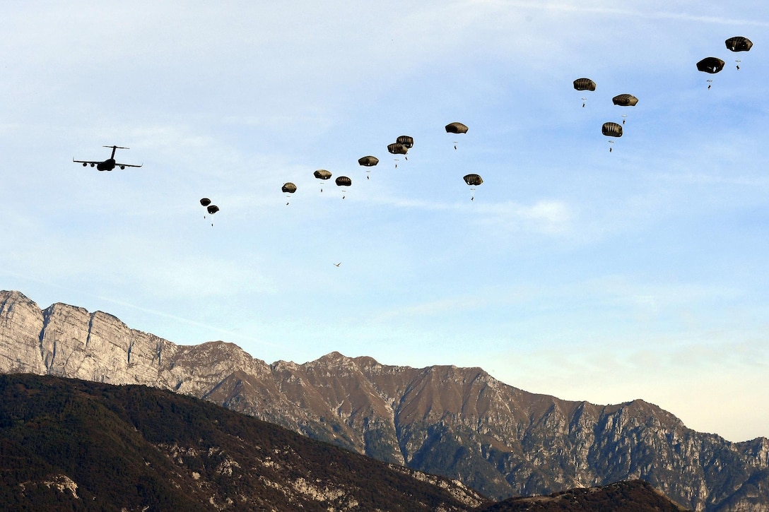 U.S. and NATO paratroopers jump out of a C-17 Globemaster aircraft as part of the Peacemaster Unity airborne exercise in Pordenone, Italy, Oct. 17, 2016. Army photo by Staff Sgt. Opal Vaughn