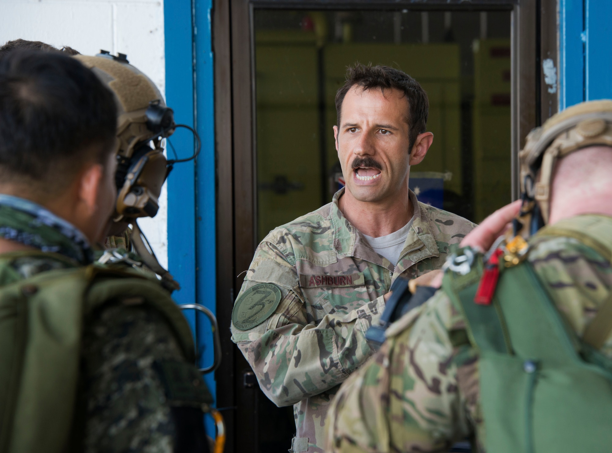 Capt. Timothy Ashburn, 1st Special Operations Squadron aircraft commander, talks with jumpmasters from Operational Detachment Alpha (ODA) 1324 and Philippine Army Light Reaction Regiment (LRR) in preparation for high-altitude, low-opening (HALO) airdrops from a MC-130H Combat Talon II at Clark Air Base, Sept. 24. Though the HALO airdrop was not an official part of Teak Piston 2016, the presence of a MC-130H in the Philippines allowed for a unique training engagement. (U.S. Air Force photo by Capt. Jessica Tait)