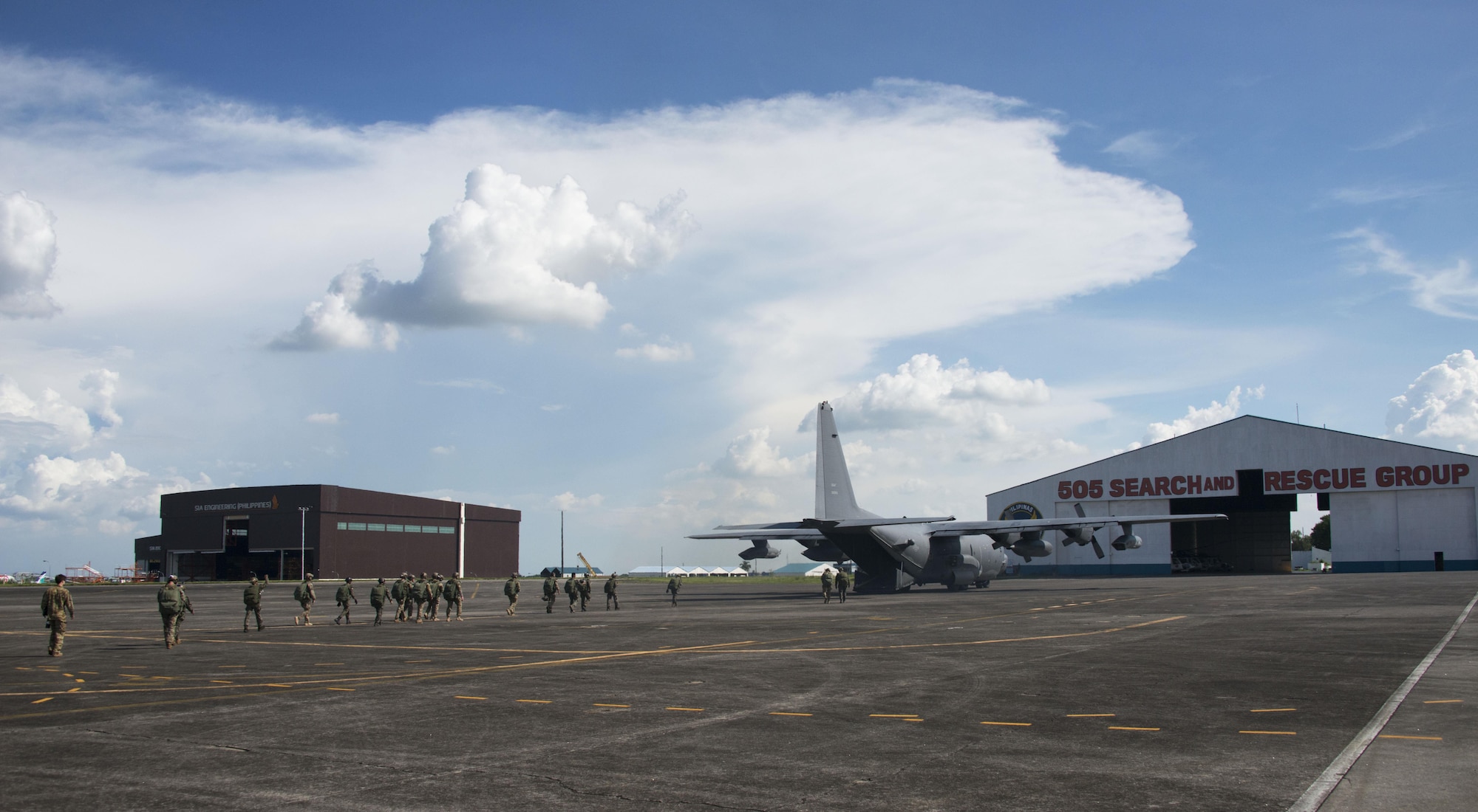 Members from Operational Detachment Alpha (ODA) 1324 and Philippine Army Light Reaction Regiment (LRR) walk to the MC-130H Combat Talon II for high-altitude, low-opening (HALO) airdrops from at Clark Air Base, Sept. 24. ODA 1324 spent six months coordinating with the Joint United States Military Advisory Group (JUSMAG), PACOM Augmentation Team, Special Operations Command Pacific (SOCPAC), and the AFP General Headquarters on a joint, combined HALO airdrop. (U.S. Air Force photo by Capt. Jessica Tait)