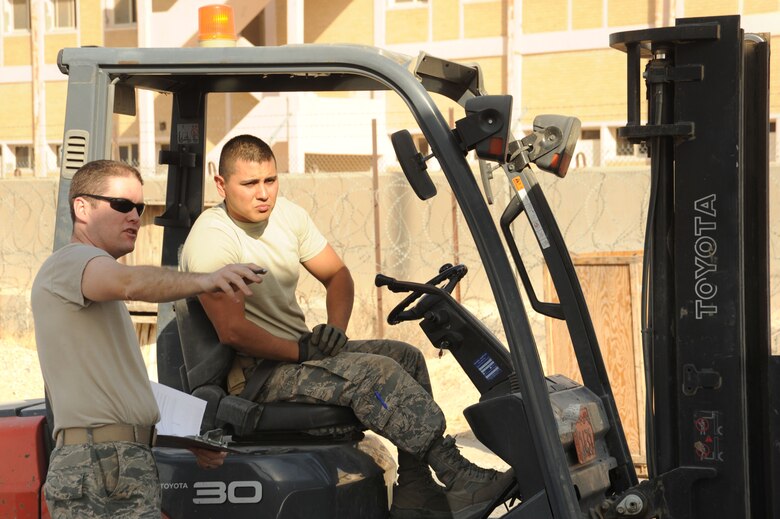 Master Sgt. Michael Glathar, 386th Expeditionary Logistics Readiness Squadron aircraft parts store NCO in-charge, left, shows Senior Airman Nicholas Contreras, 386 ELRS materiel management journeyman, where to put a pallet in the APS storage area Oct. 13, 2016 at an undisclosed location in Southwest Asia. The APS is responsible for storing and issuing weapon system spares to aircraft maintainers and coordinating with the states to send back broken parts to be fixed. (U.S. Air Force photo/Senior Airman Zachary Kee)