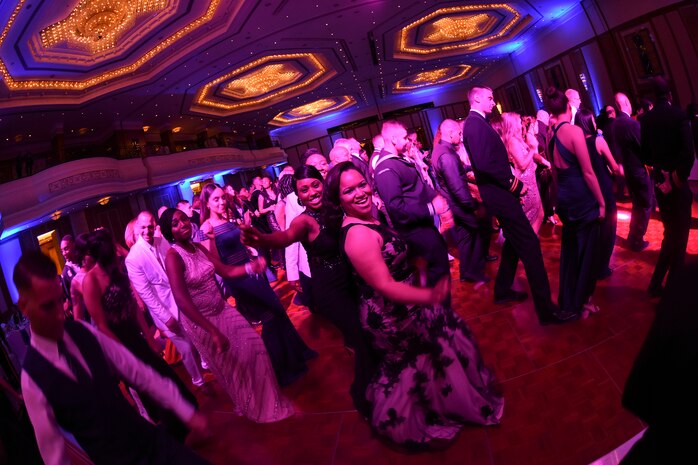 In the center of the dance floor, Air Force Tech Sgt. Saleisa Lampkin, left, and Petty Officer 1st Class Diamond Cameron, right, dance together and pose for the camera during the 2016 Navy Ball at the Gulf Hotel Convention Center in Manama, Bahrain. The Navy Ball is an annual event, which celebrates the heritage, history and the day Congress created the United States Navy on Oct. 13, 1775. The U.S. Navy has a 241-year heritage of defending freedom and projecting and protecting U.S. interests around the globe.