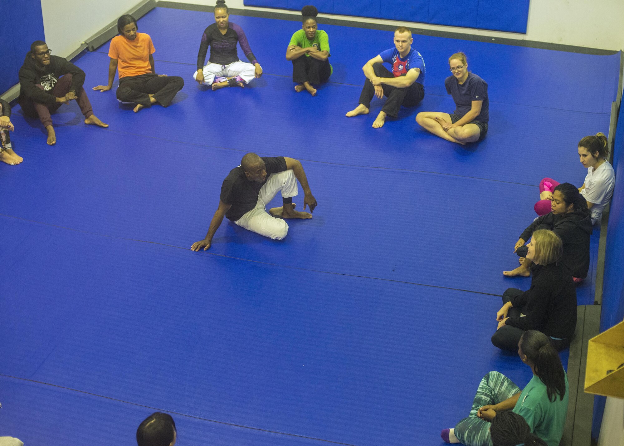 Major Tyrone Bess, 374th Security Forces Squadron commander, and head Gracie Jiu-Jitsu instructor sits in the middle of the class while everyone introduces themselves during the kick-off event at the Samurai Fitness Center 15 Oct. 2016 at Yokota Air Base, Japan. The free self-defense class is available for anyone and is scheduled to start on 18 Oct. 2016 from 5-6 p.m., every Tuesday and Friday for 10 weeks. (U.S. Air Force photo by Airman 1st Class Donald Hudson/Released) 
